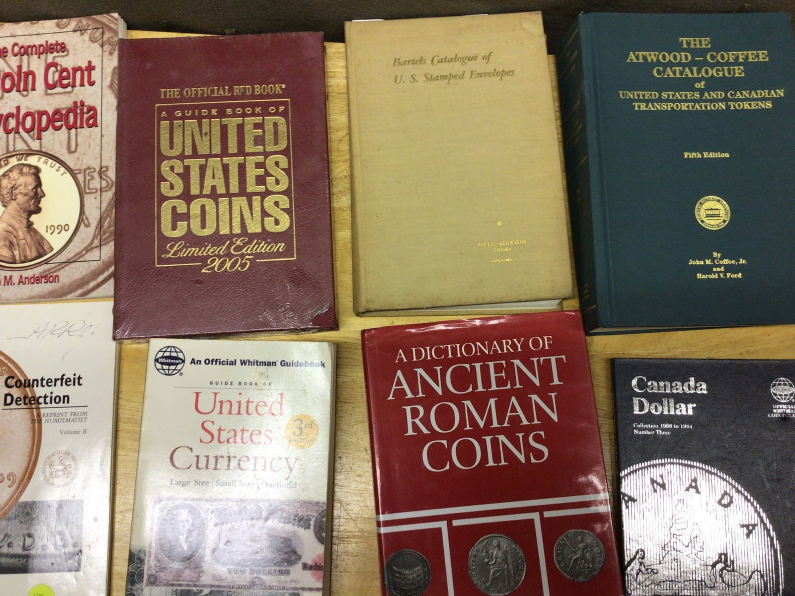 Reference Books on Coins, U.S. Currency, and Related Topics: This lot includes a group of reference books relating to coins, currency, and numismatics. Titles include 'The Complete Lincoln Cent Encyclopedia' by Shane M. Anderson, 'The Official Red Book: A Guide
