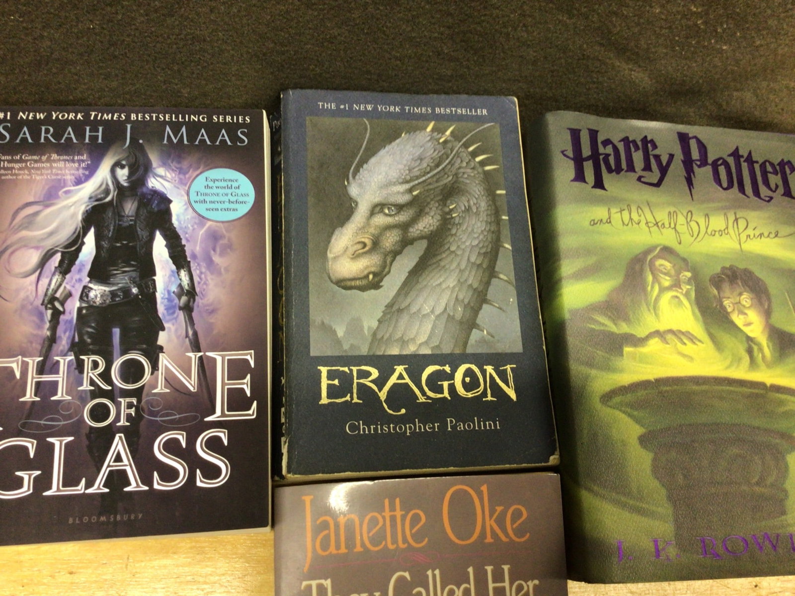 Books Including Harry Potter, Throne of Glass, and More: This lot includes six books: 'Harry Potter and the Half-Blood Prince' by J.K. Rowling, 'Throne of Glass' by Sarah J. Maas, 'Eragon' by Christopher Paolini, 'They Called Her Mrs. Doc' by Janette Oke,
