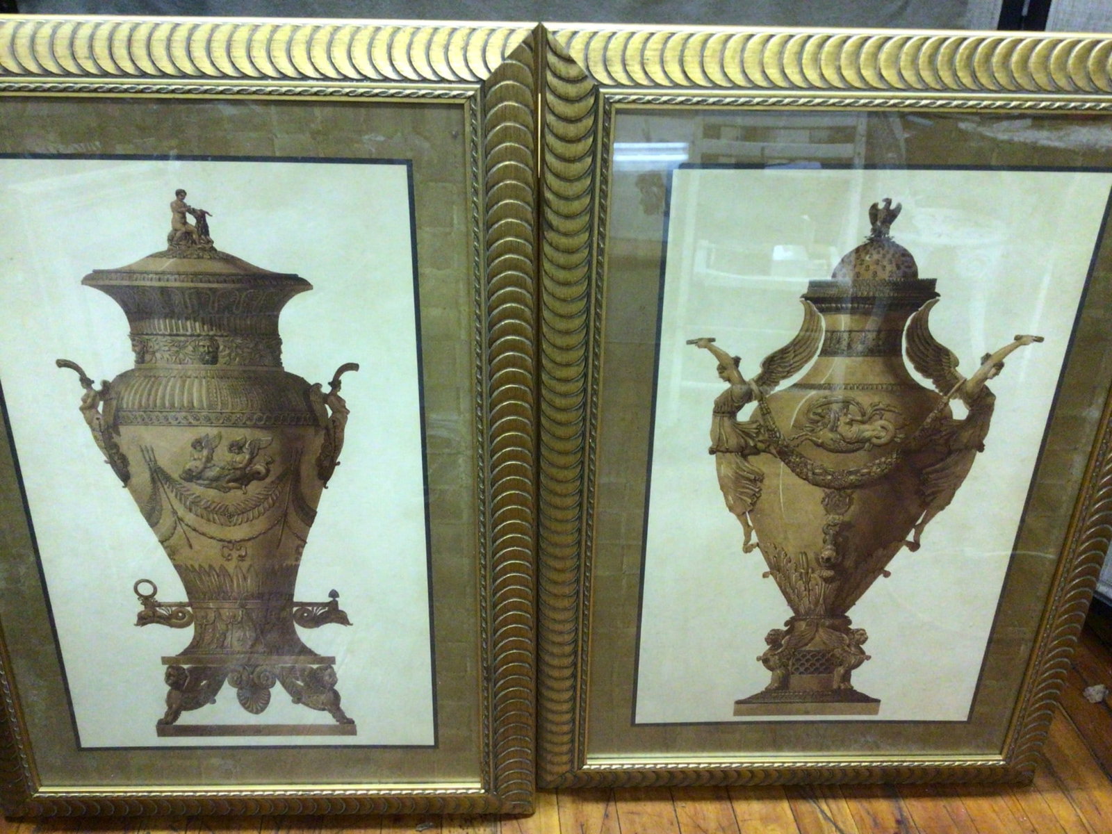Framed Prints Of Ornate Classical Vases, 40 x 29 Inches Each: Framed prints featuring ornate classical-style vases. Each frame measures 40 inches in height and 29 inches in width. The prints are set in matching gold-tone frames with a textured border. The