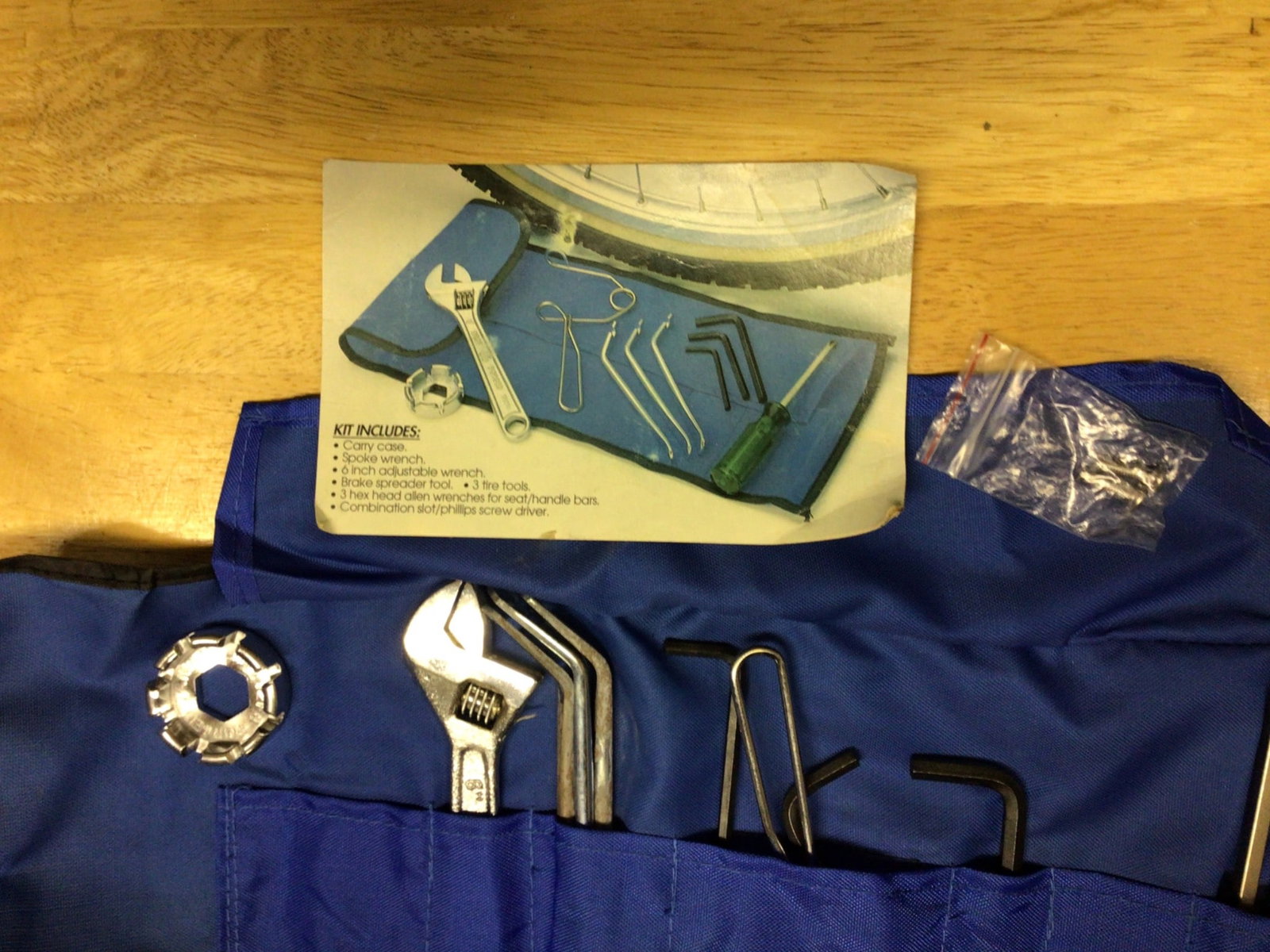 Bike Repair Kit with Wrenches, Allen Keys, and Saddle Bag: This bike repair kit includes essential tools such as a wrench, Allen keys, tire levers, spoke adjuster, screwdrivers, and patches, all stored in a blue roll-up pouch. The kit also comes with a compac