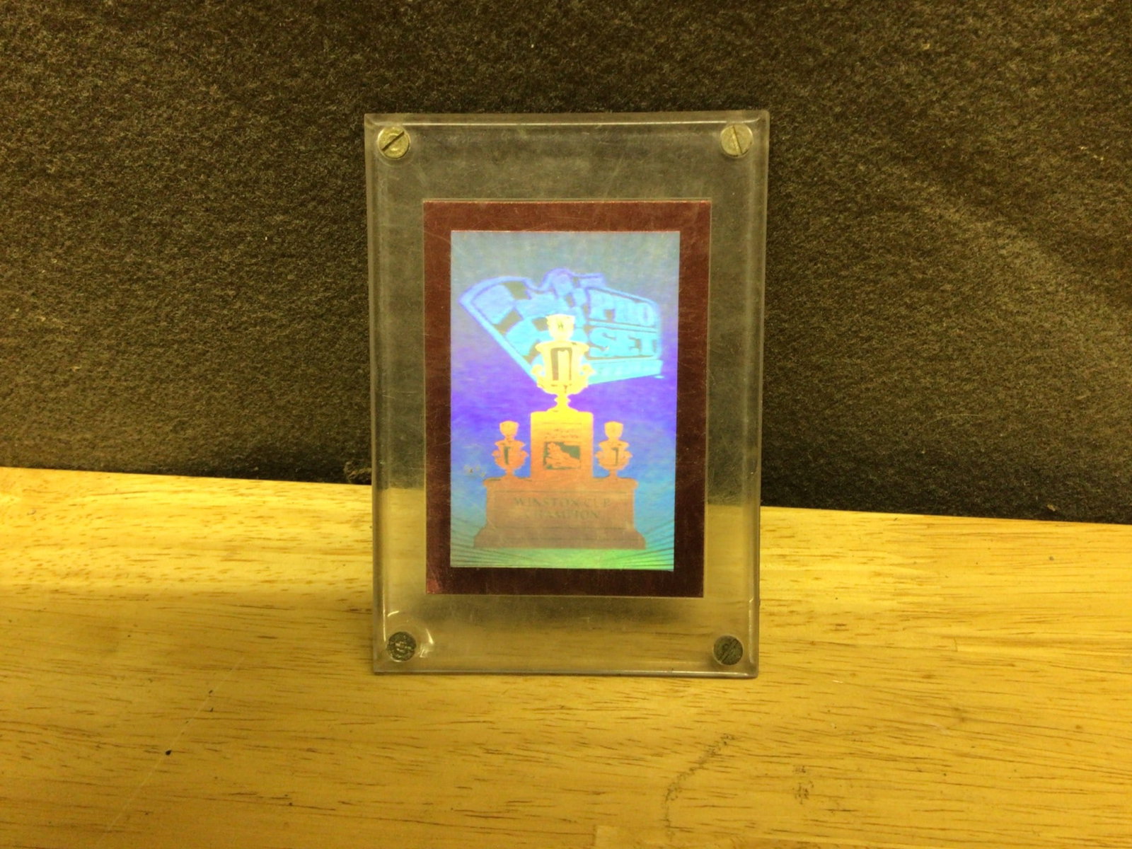 Winston Cup Trophy Holographic Display Plaque with Description Plate: A holographic display plaque commemorating the Winston Cup Trophy. Includes visual holographic elements of the trophy and a description plate on the reverse side. Marked with '2003 GP 5000' below the