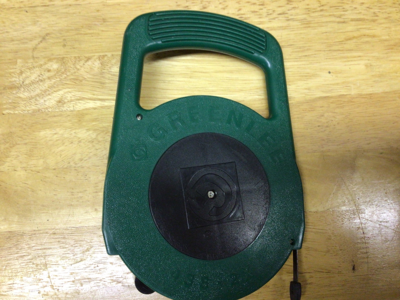 Greenlee 438-2X Hand Crank Fish Tape: Greenlee Model 438-2X hand crank fish tape tool. Features a green plastic housing with an ergonomic handle and a durable black crank mechanism. Includes integrated tape guide with end fitting.