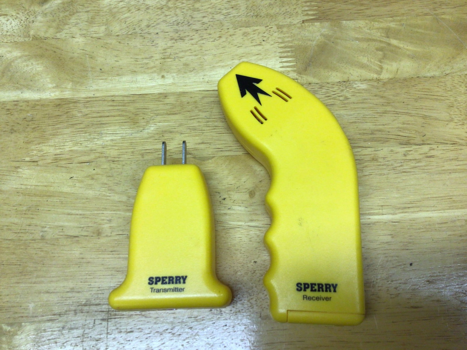 Sperry Outlet Circuit Tester with Transmitter and Receiver: This is a Sperry outlet circuit tester package, including a transmitter and a receiver designed for electrical testing. The items feature yellow plastic casing with black and printed labels. The