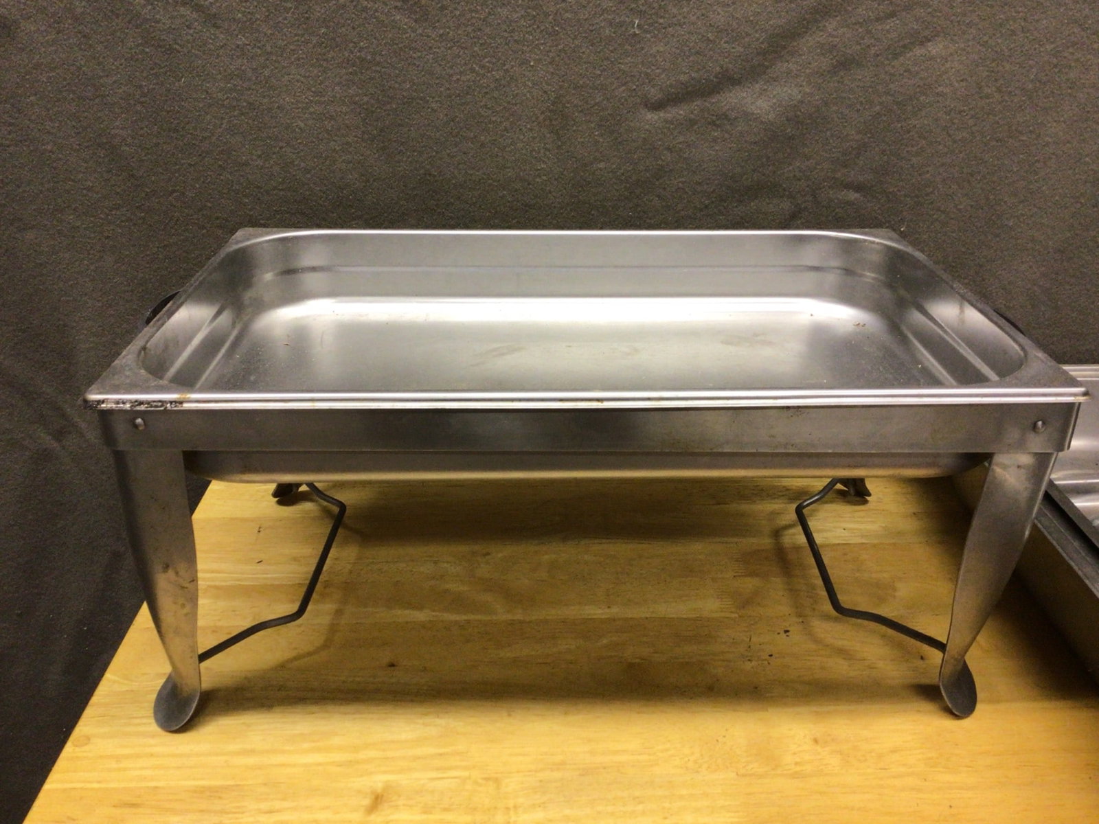 Stainless Steel Chafing Dish With Lid and Food Tray, 100% Complete: This is a stainless steel chafing dish set, including a lid, food tray, and base. It measures approximately 22 inches in length, as shown in the images. The item is described as 'new but a little old'