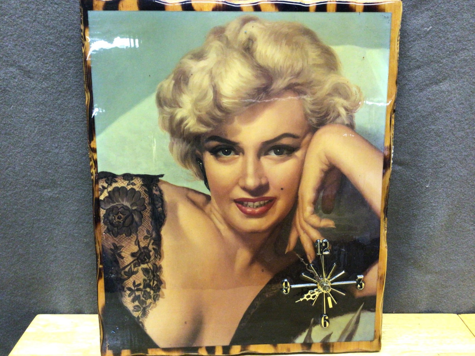 Wooden Wall Clock Featuring a Portrait Image and Tiger Stripe Border: This is a wooden wall clock featuring a portrait image of a blonde woman in a tiger-striped border design. The clock face has gold-colored hands and numeric indicators with a quartz movement