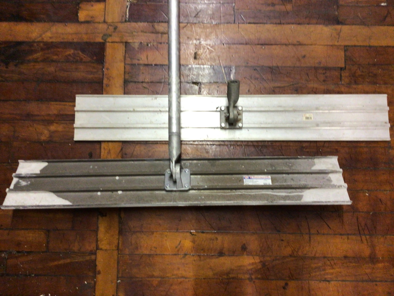 Marshalltown Magnesium Bull Float with Handle and QLT Extruded Float: This lot includes a Marshalltown Magnesium Bull Float, model 13849, and a QLT Extruded Float, model number 84-HD. The bull float is designed for concrete smoothing and includes a compatible metal
