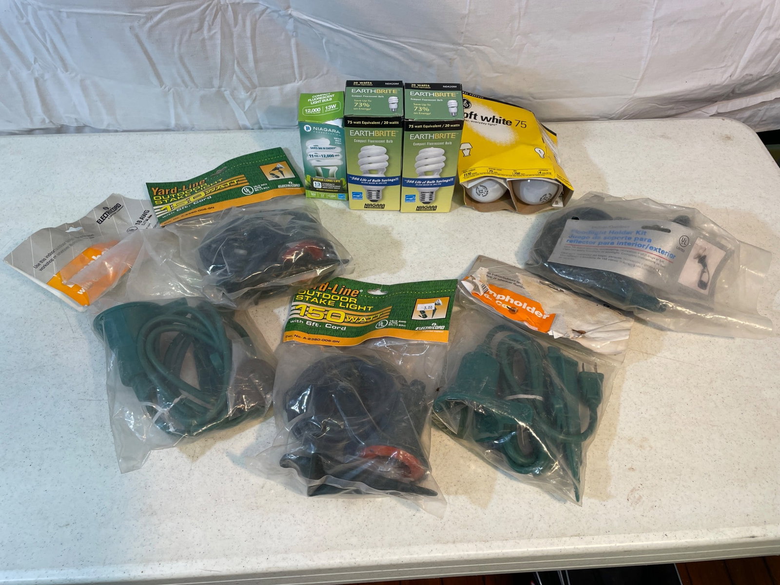 Lighting Accessories Including Holders, Cords, Bulbs, and Kits: This lot includes various lighting items: (2) Lampholder with 6 ft Cord by ElectriCore, (2) Yard-Lite Outdoor Stake Lights with 15 ft Cords, (1) Floodlight Holder Kit (indoor/outdoor, UL listed), (3)