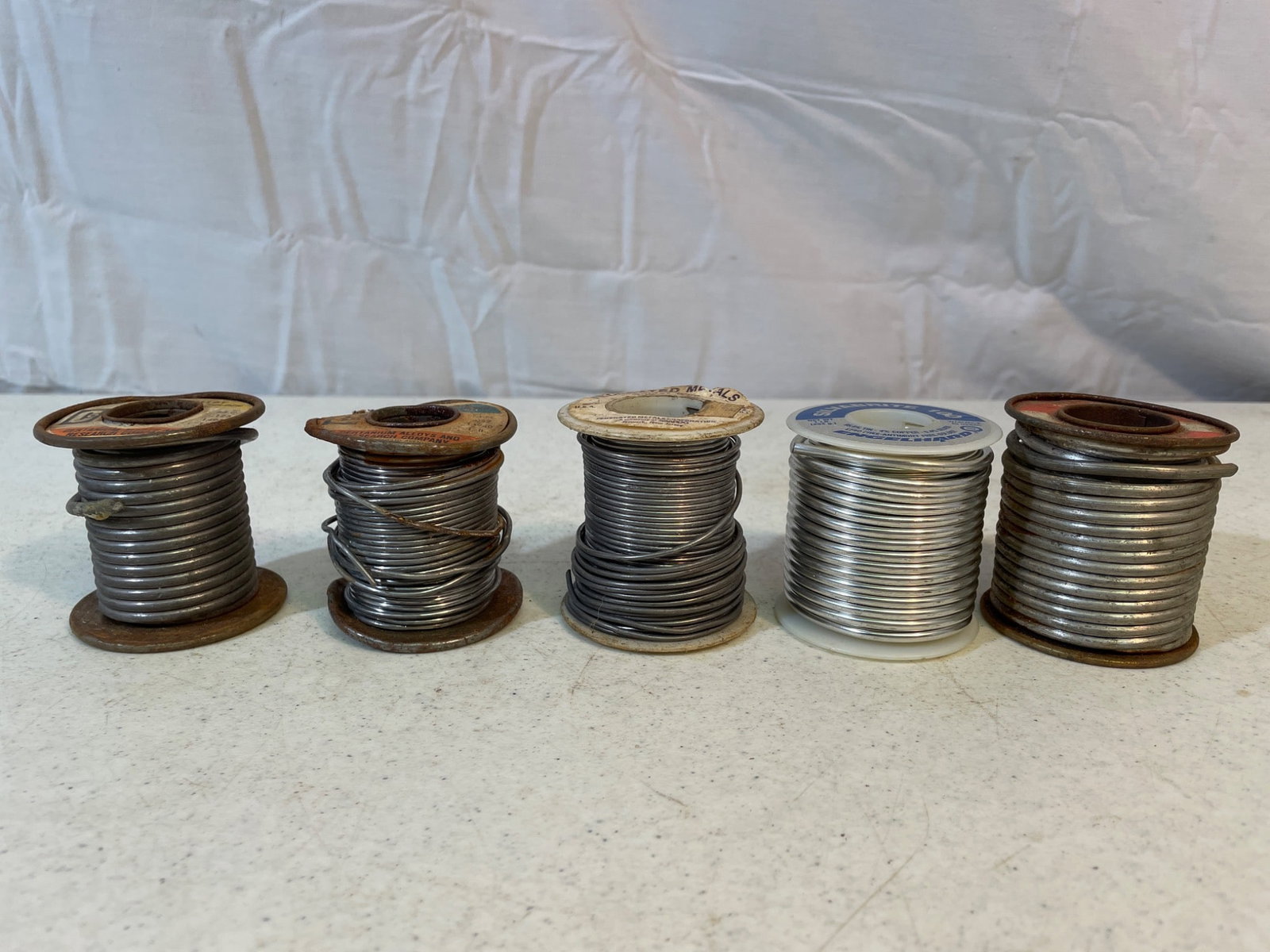 Spools of Rosin Core and Solid Wire for Soldering and Repairs: Five spools of various types of soldering wire. Brands include Sta-Brite, Ersin Multicore, and Bernzomatic. Composition includes rosin core and solid wire types. Individual spool weights and full