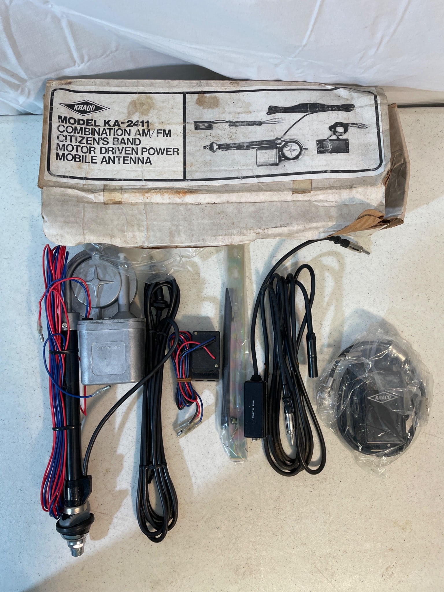 Trunk Model KA-2411 Motor Driven Power Mobile Antenna: Trunk Model KA-2411 Combination AM-FM Citizen Band antenna. Includes motor-driven power feature, mounting hardware, wiring, and installation instructions. Condition appears to be unused, with original