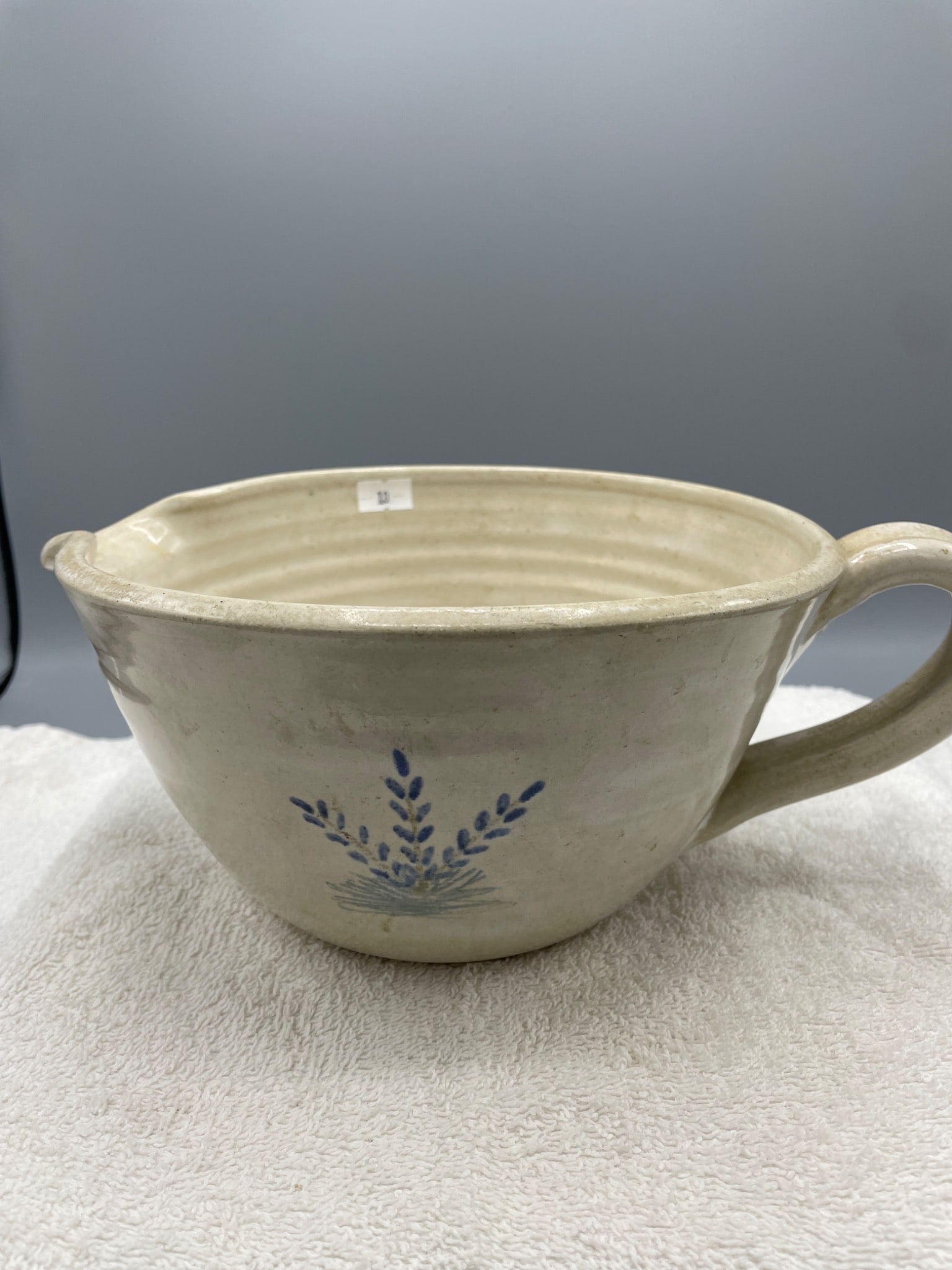 Handmade Ceramic Batter Bowl From Seagrove, NC, Signed And Dated: This is a handmade ceramic batter bowl with a handle and spout, featuring a simple floral design in blue. The bottom is marked 'Seagrove Traynham Pottery, NC, P.K., 2000' and inscribed 'Not Like