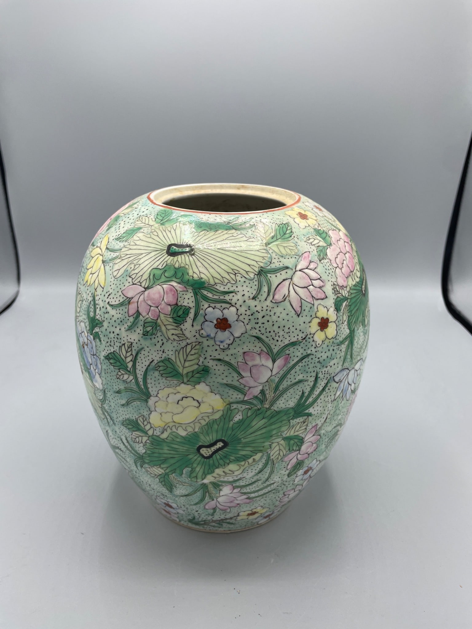 Chinese Porcelain Vase with Floral Motif and Marked Base: This is a Chinese porcelain vase with floral decoration and pastel accents. The piece displays a distinct red mark on the base, possibly indicating its origin or maker. The vase measures