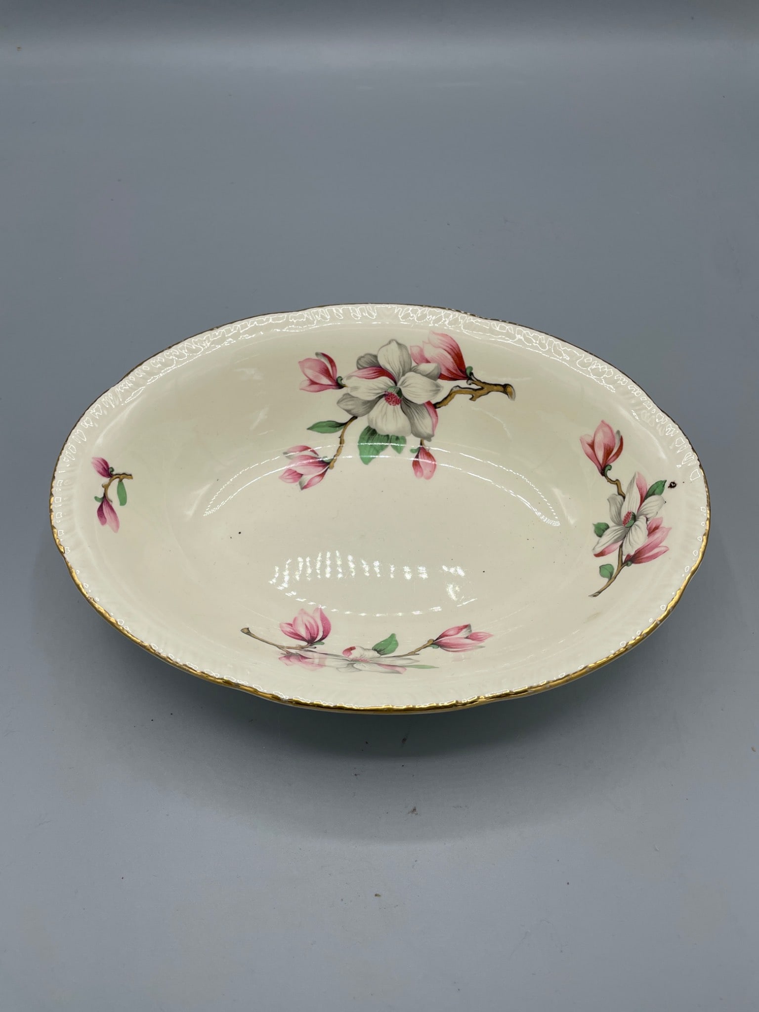 Homer Laughlin L56N6 Oval Serving Bowl With Floral Design: This is a Homer Laughlin oval serving bowl, marked with 'Made in U.S.A.' and 'L56N6' on the base. The bowl features a floral design with gold-trim accents. It measures approximately 2.5 inches in