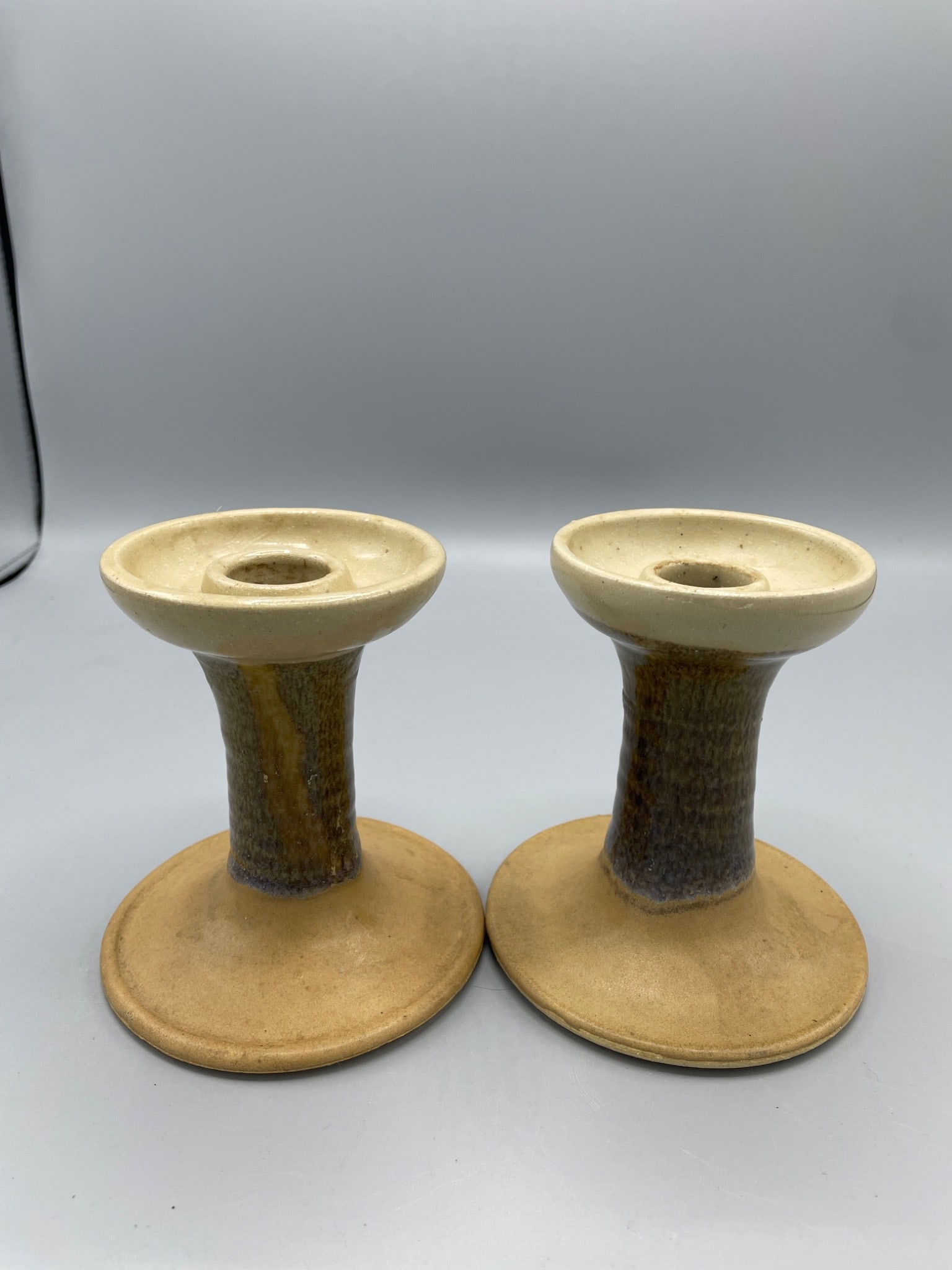 Phil Morgan Pottery Candleholders, Signed, 1992: This lot includes a pair of handmade pottery candleholders by Phil Morgan, signed and dated 1992 on the bottom. Each piece is crafted in Seagrove, NC, with a characteristic glaze finish. The candlehol