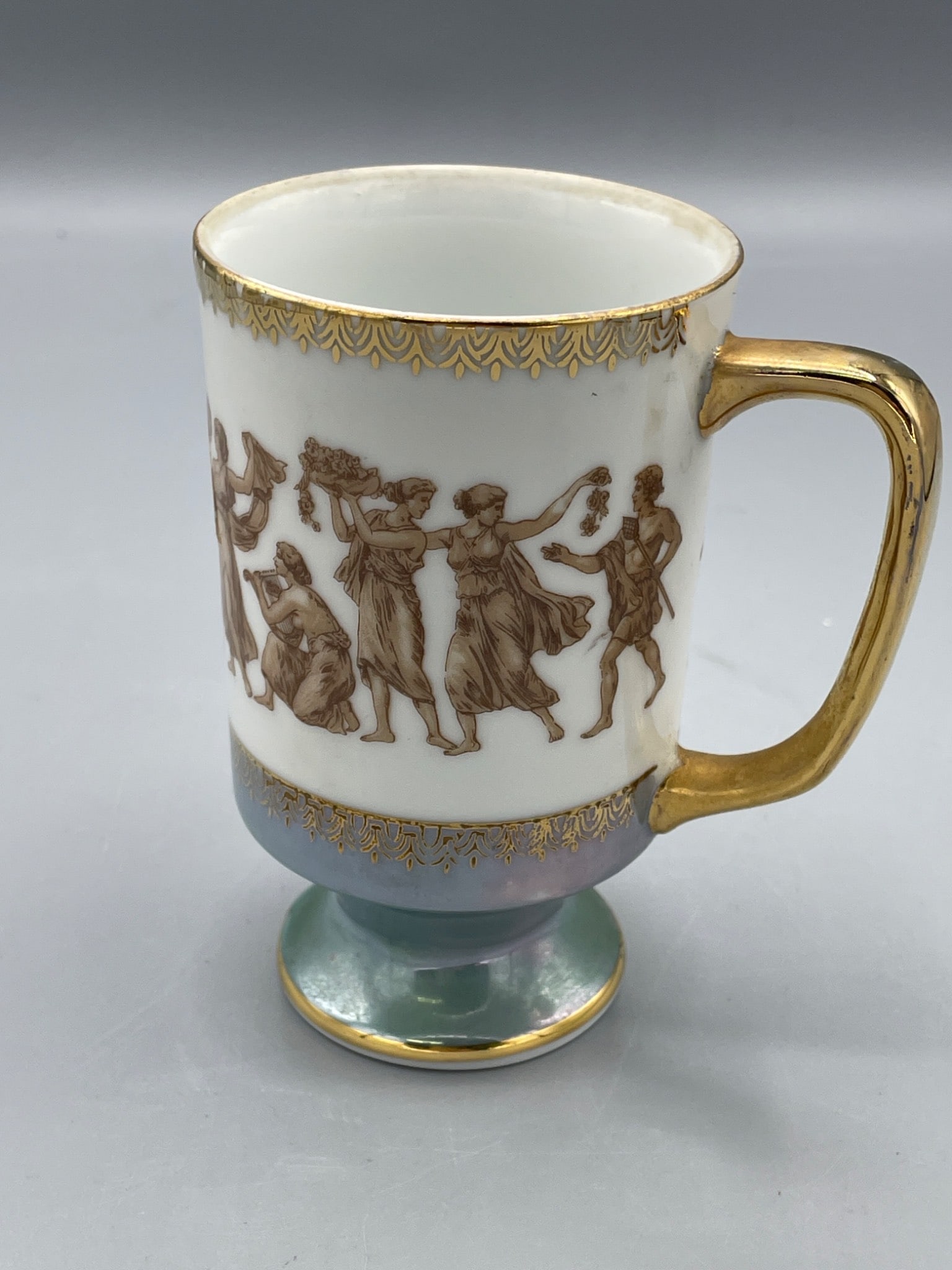 Royal Crown Greek Classic 55/1022 Mug, Made in Japan: This listing features a Royal Crown 'Greek Classic' ceramic mug, model number 55/1022, made in Japan. Distinctive characteristics include gold embellishments, a depiction of Greek figures, and a