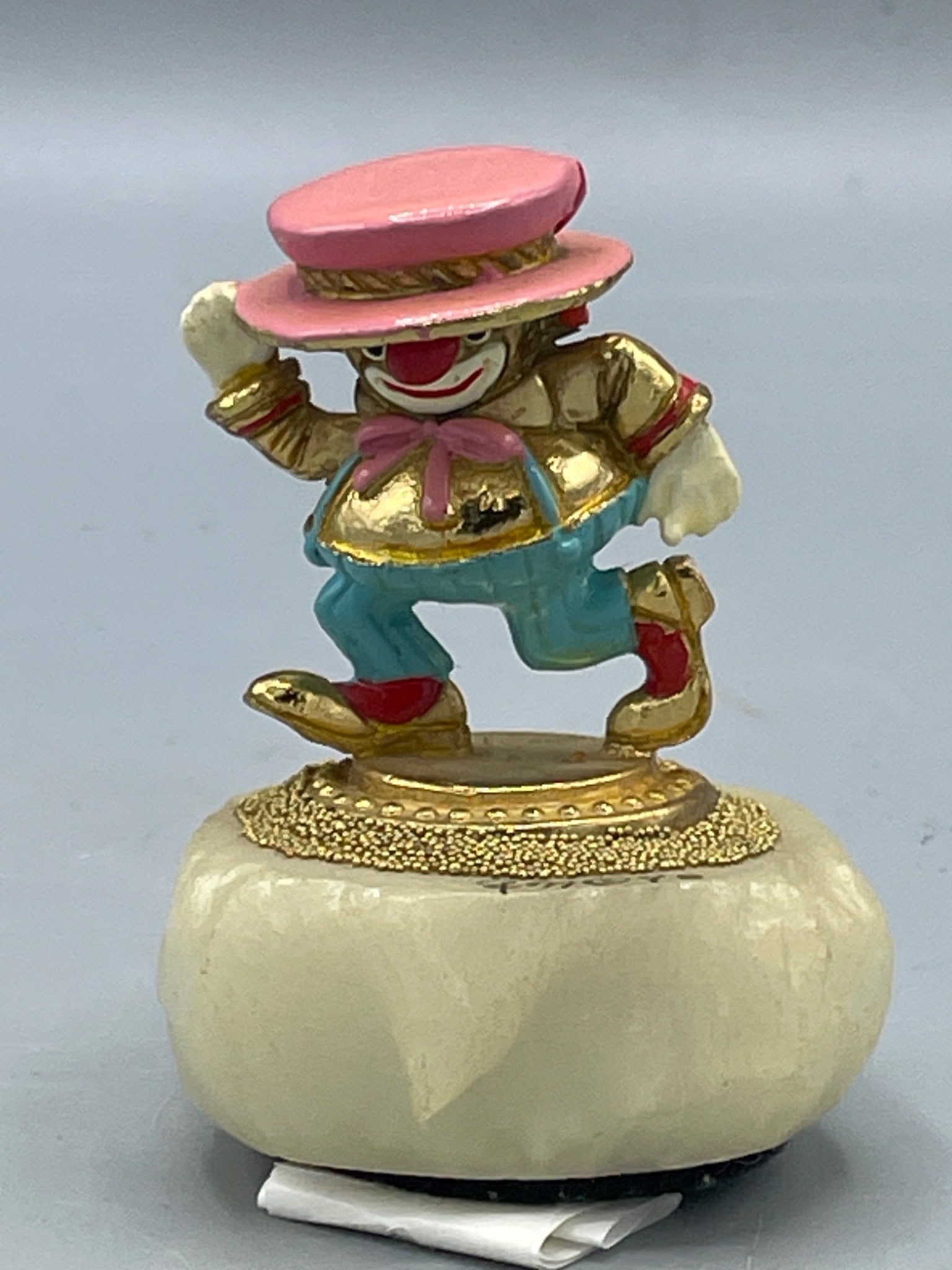 Ron Lee Clown Figurine, Limited Edition 117/2500: This is a clown figurine featuring a gold-tone finish with a pink hat and colorful outfit. It is mounted on a base with a felt-covered bottom for stability. The item is individually numbered on the