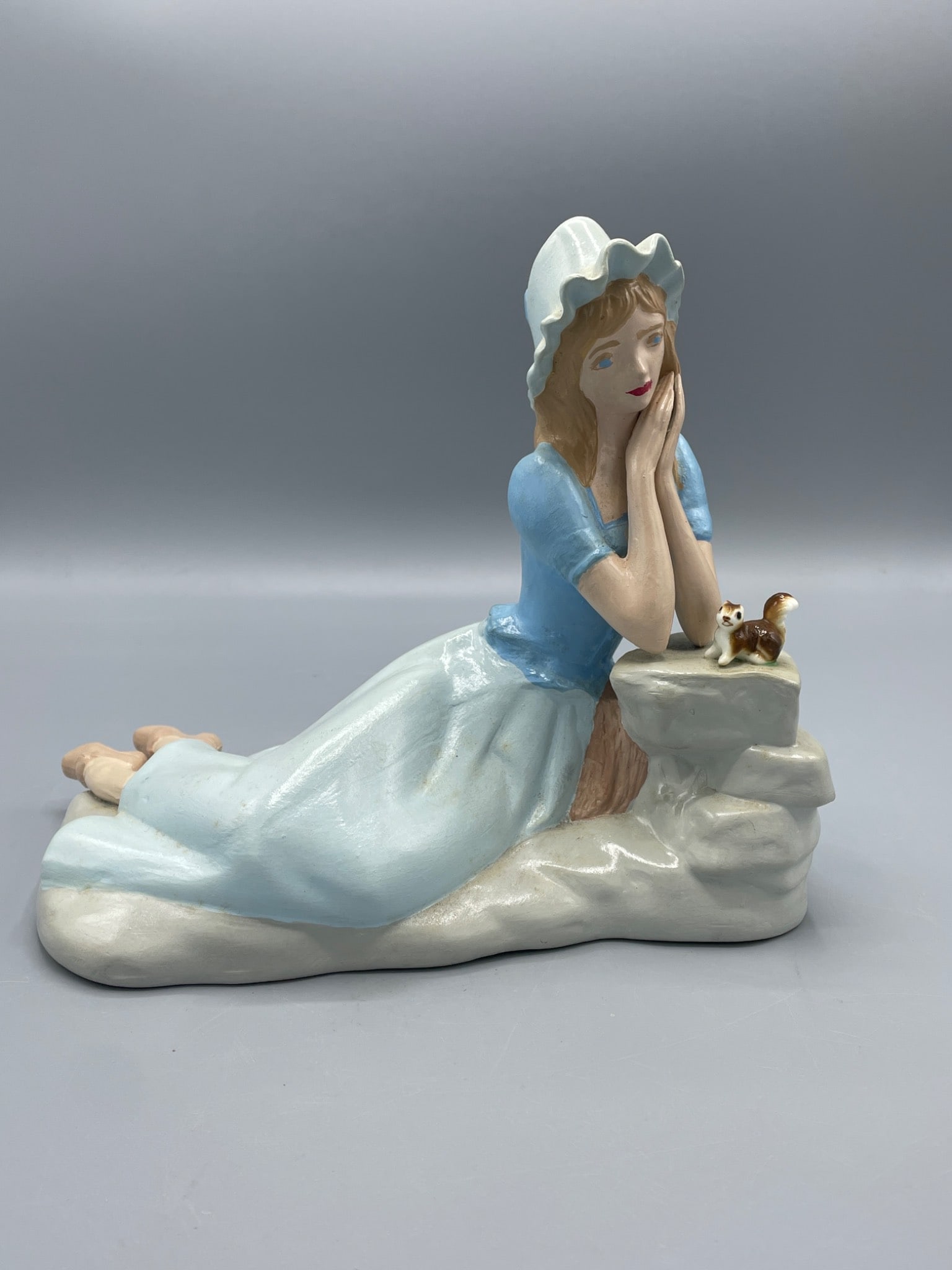 Hand-Painted Ceramic Figurine of Woman With Bonnet and Cat on Rock Formation (1 of 7)