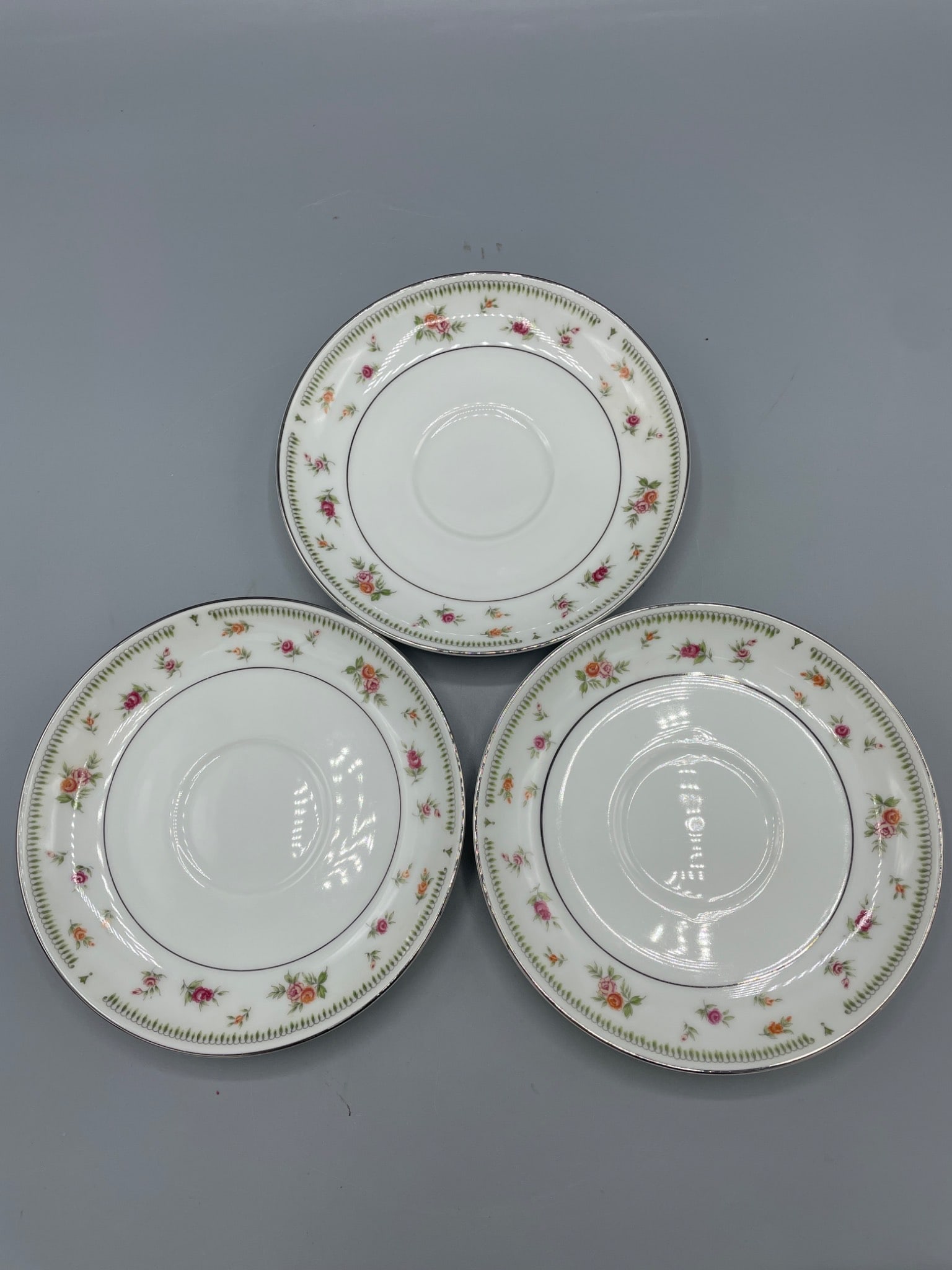 Three Abingdon Fine Porcelain China Saucers, Made in Japan: Three Abingdon Fine Porcelain China saucers, each featuring a floral pattern with fine detailing. Manufactured in Japan with clear markings on the bottom. Each saucer measures approximately 6 inches i