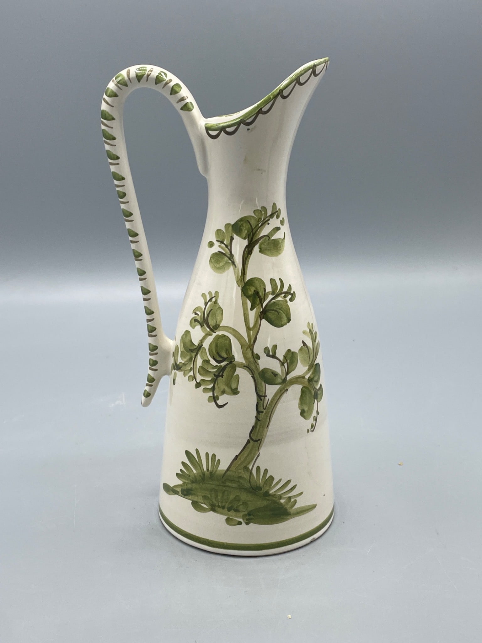 West German Ceramic Ewer with Green Floral Design, stamped 221/2: This ceramic ewer features a green floral design and an elongated handle. The base is marked with â€˜Made in W Germanyâ€™ and