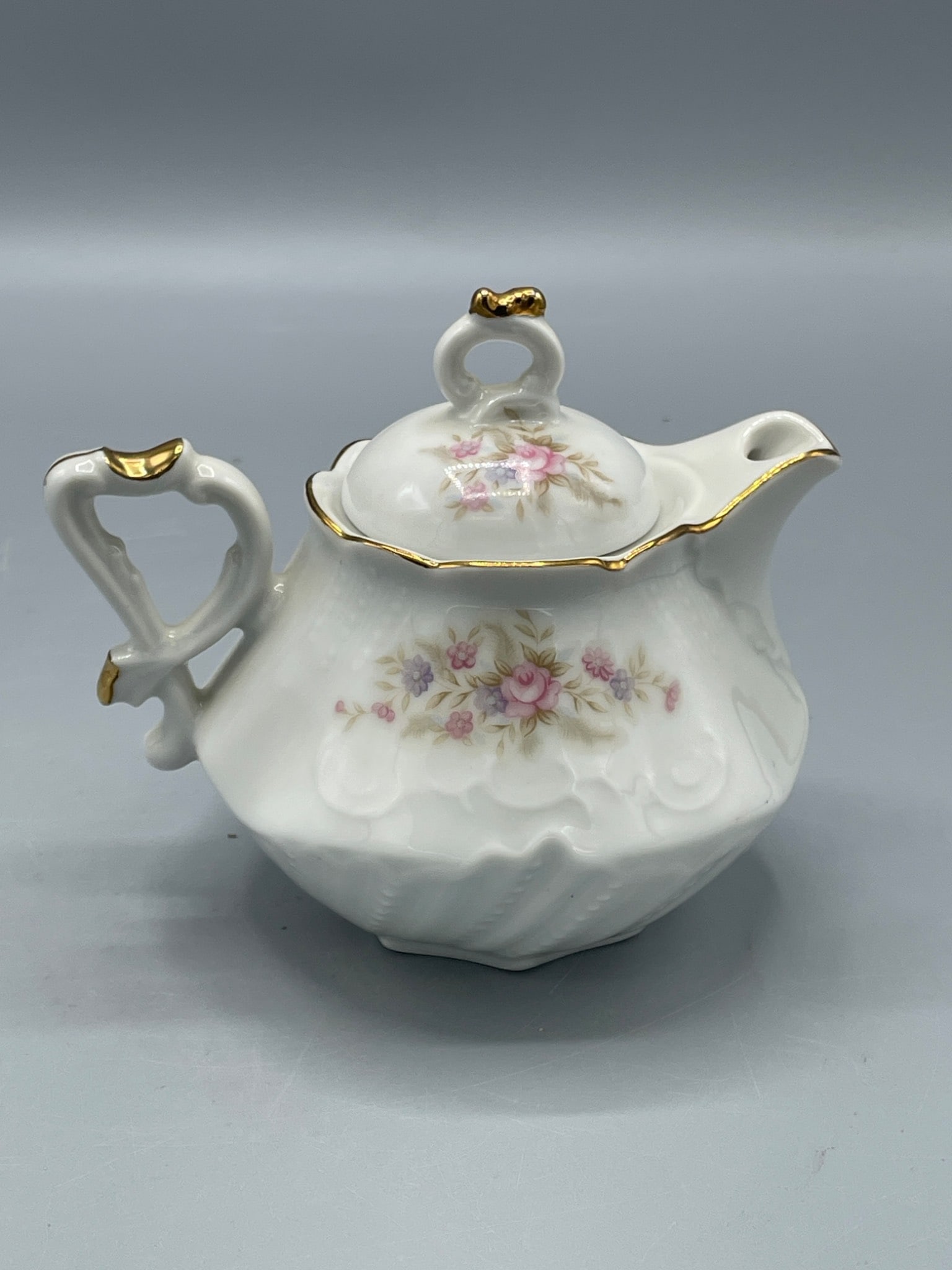 Lefton China 6841 Hand-Painted Creamer with Floral Design: This is a porcelain creamer from Lefton China, model 6841, featuring hand-painted floral patterns and gold accent trim. It is marked with 'Lefton China Hand Painted 6841' along with its original red