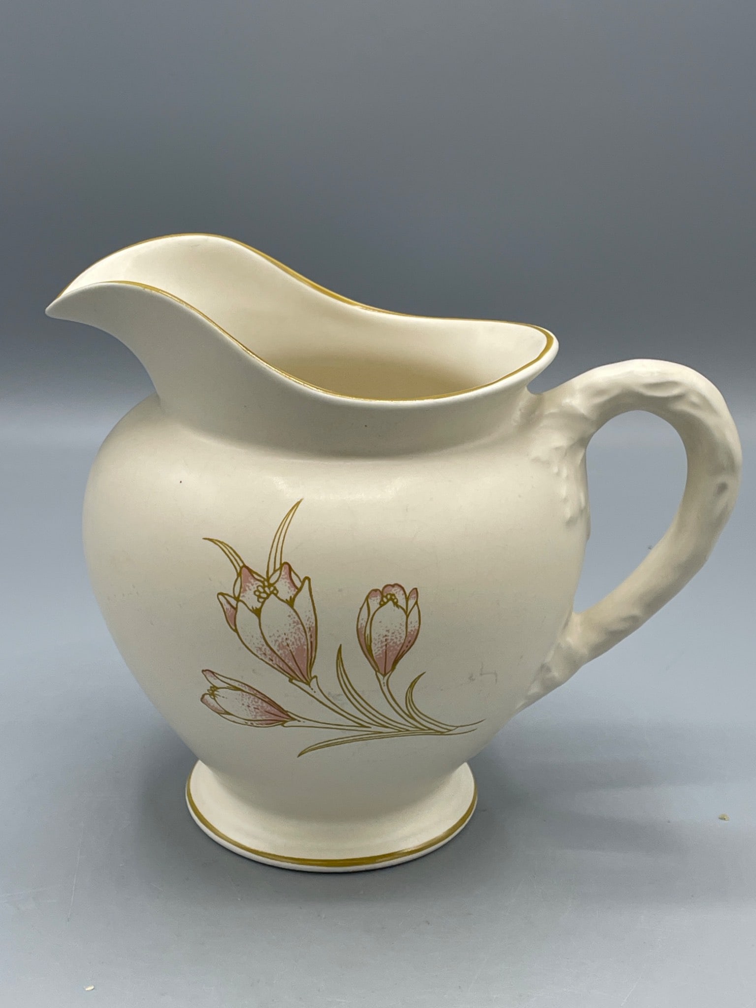 Coloroll Cream Pitcher With Floral Design, Made in England: A cream pitcher marked 'Coloroll Made in England' on the base. Features a floral design with pink flowers and gold accents on both sides. It measures approximately 5 inches tall and has a molded