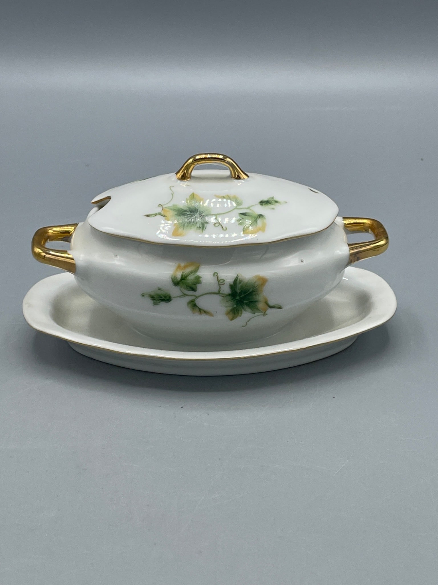 Porcelain Tureen with Lid and Tray, Royal Crown Marked 1446: This porcelain tureen, featuring a covered lid and resting tray, showcases a pattern of floral motifs and gold-tone handles. The base is stamped with 'ROYAL CROWN' and the number '1446.' The item meas