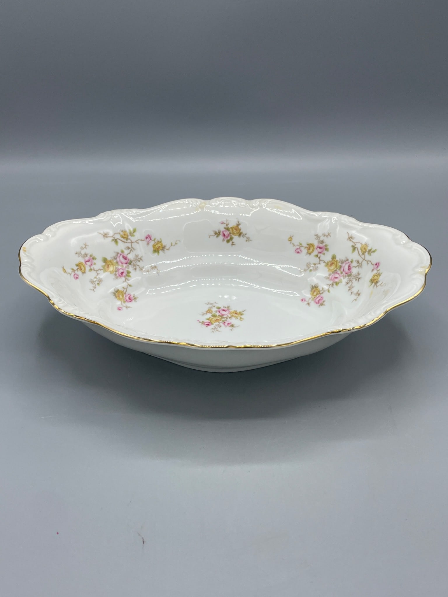 Johann Haviland Bavaria Germany Floral Oval Serving Bowl with Gold Trim: This is an oval serving bowl by Johann Haviland, crafted in Bavaria, Germany. It features a floral pattern with pink and green accents, and delicate gold trim. The bottom is marked "Johann Haviland