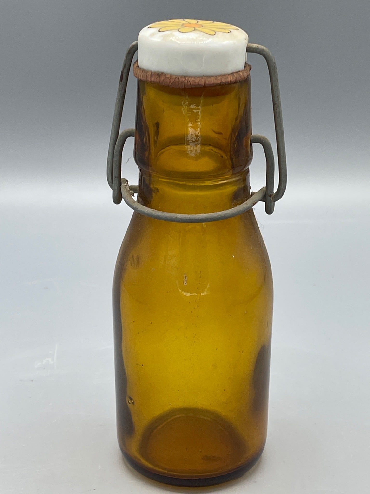Amber Glass Bottle With Ceramic Daisy Cap and Wire Clamp Closure (1 of 5)