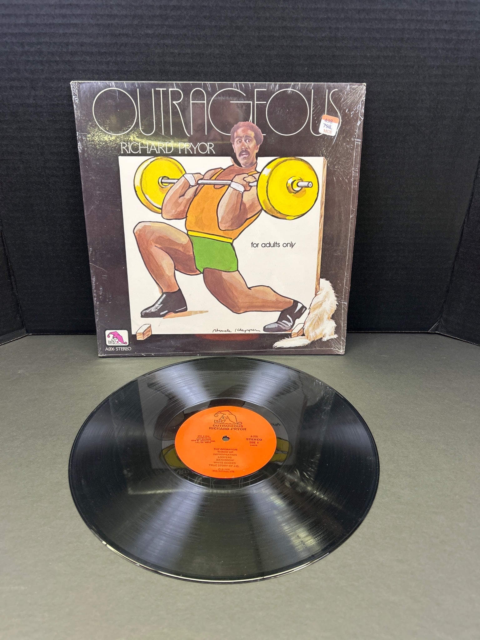 Outrageous Comedy Vinyl Record by Richard Pryor, 1974: This is Richard Pryor's 1974 vinyl record titled "Outrageous," released under Laff Records. The cover design and illustration are credited to Rhonda Klapper, with production by David Drozen and