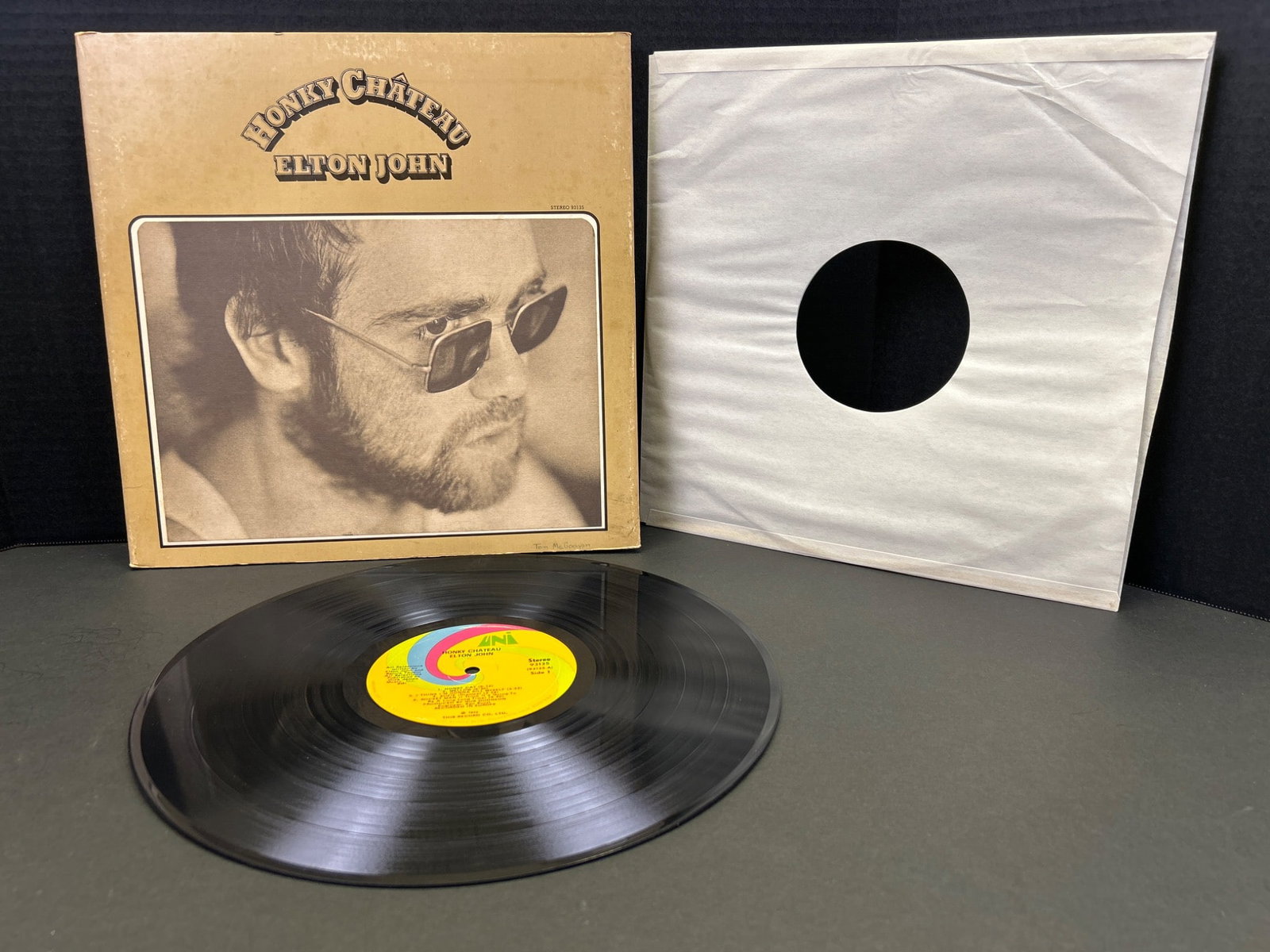 Elton John 'Honky Chateau' Vinyl Record, 1972 Original Issue with Gatefold Sleeve: Elton John's 'Honky Chateau,' featuring its original gatefold sleeve and lyric inserts, released in 1972 under Uni Records (Catalog #93135). Includes the LP record with the iconic yellow and red Uni