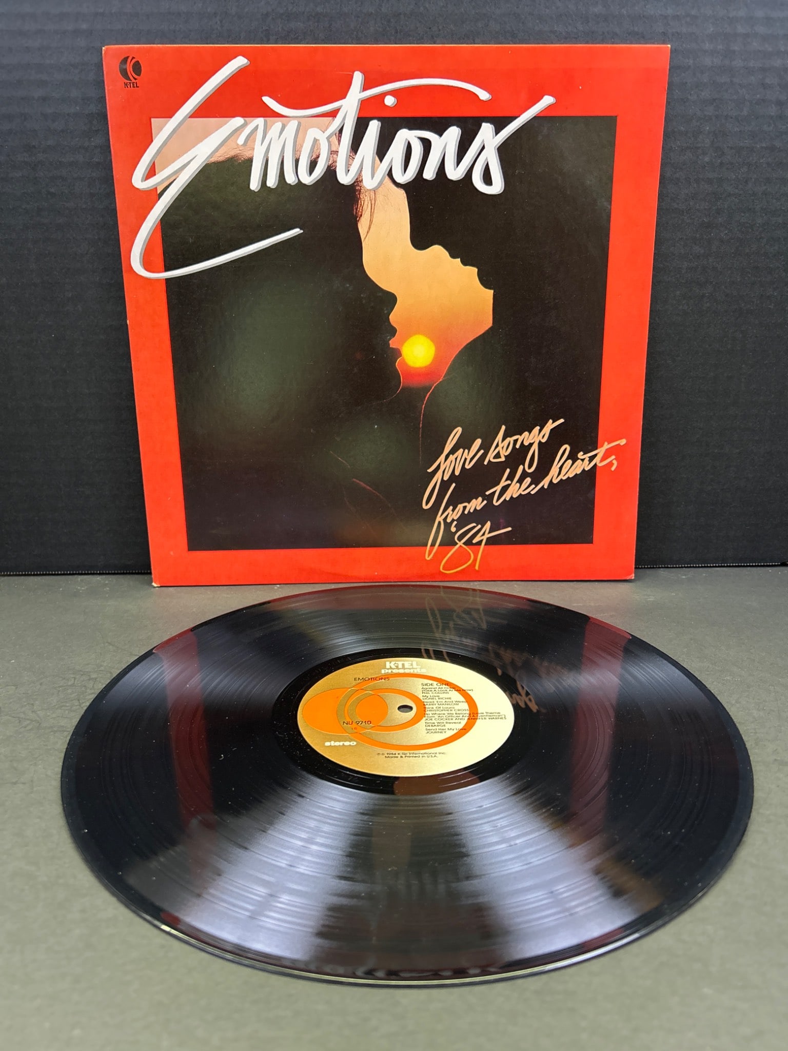 Emotions 'Love Songs From The Heart' Vinyl Record Album: Emotions 'Love Songs From The Heart' vinyl record album. Includes original outer sleeve featuring artwork with song list details on the back cover. The record has a classic orange label and is