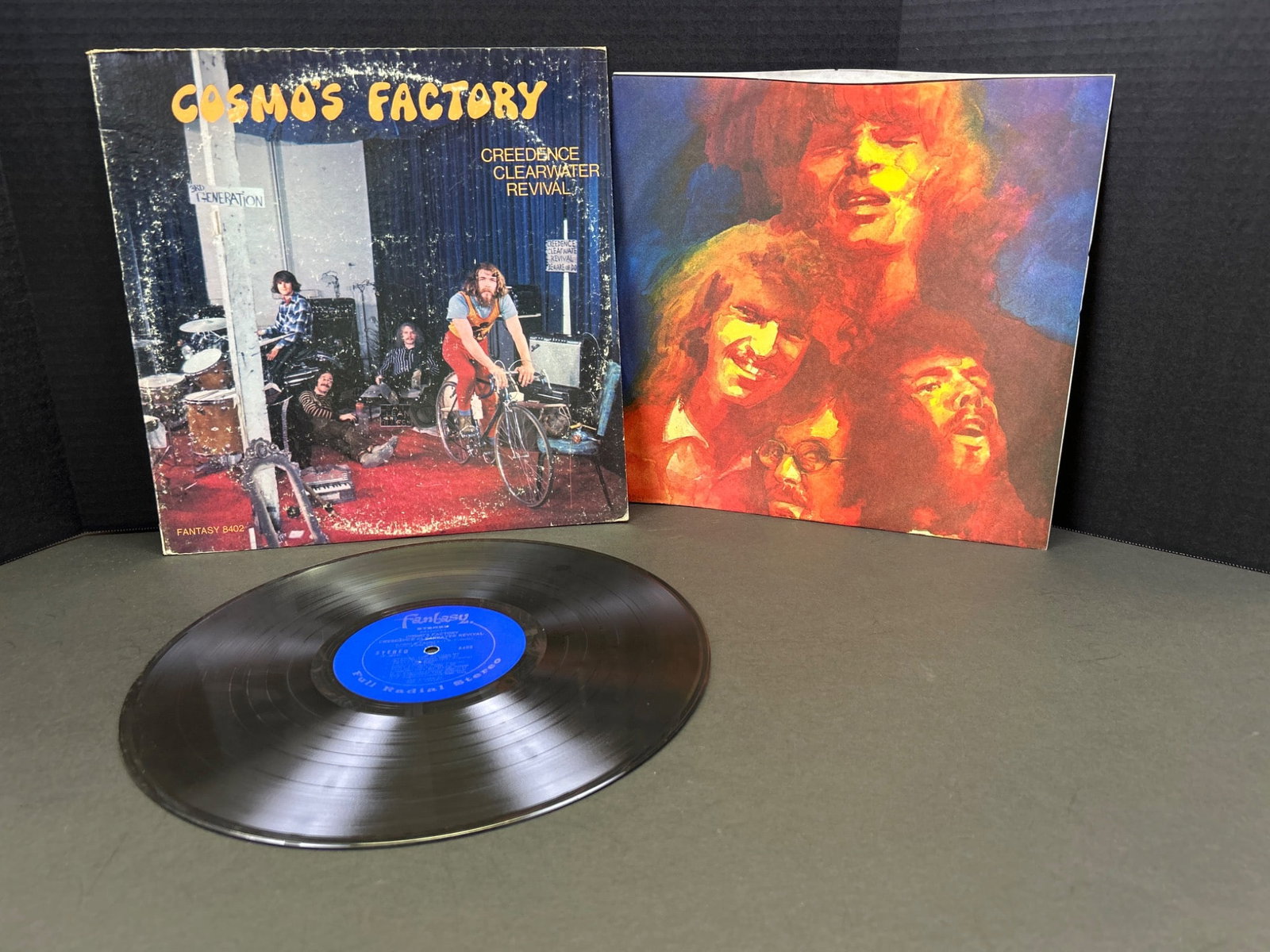 Creedence Clearwater Revival 'Cosmo's Factory' Vinyl Album with Original Sleeve: Original vinyl record of 'Cosmo's Factory' by Creedence Clearwater Revival, released in 1970. Includes original sleeve featuring album artwork and liner notes. Vinyl appears to be in playable
