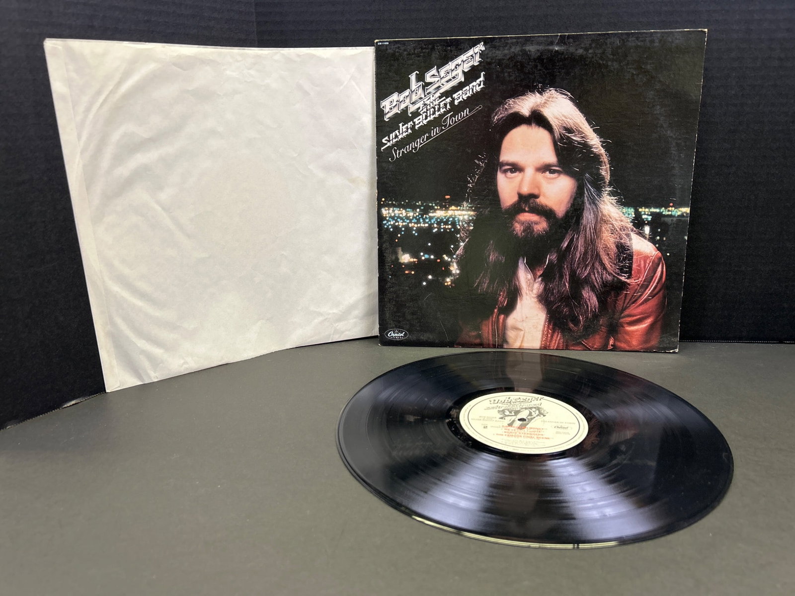 Bob Seger & The Silver Bullet Band - Night Moves Vinyl Record Album: A vinyl record album of 'Night Moves' by Bob Seger & The Silver Bullet Band. Released by Capitol Records with catalog number ST-11557, this pressing from 1976 includes the original outer sleeve and