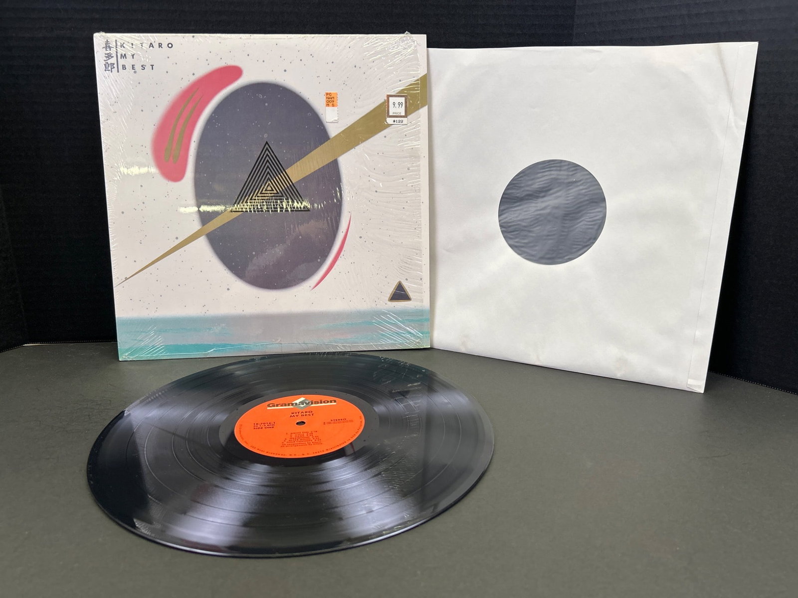 Vinyl Record with Cover Art and Insert Sleeve: This lot includes a vinyl record featuring its original protective sleeve and an outer jacket with abstract cover art. Please review photos for condition details.