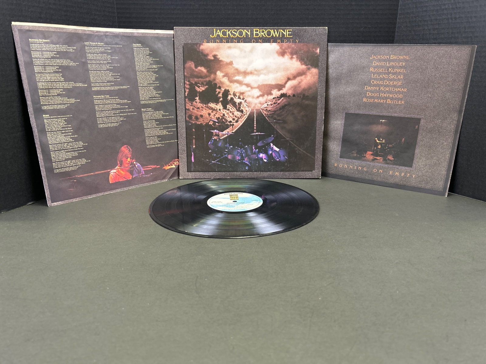 Jackson Browne â€“ 'Running on Empty' LP, Asylum Records, 1977: This is the 1977 album 'Running on Empty' by Jackson Browne on Asylum Records (catalog #6E-113). The LP includes a gatefold cover with images, lyrics, and notes. The record is a stereo pressing with