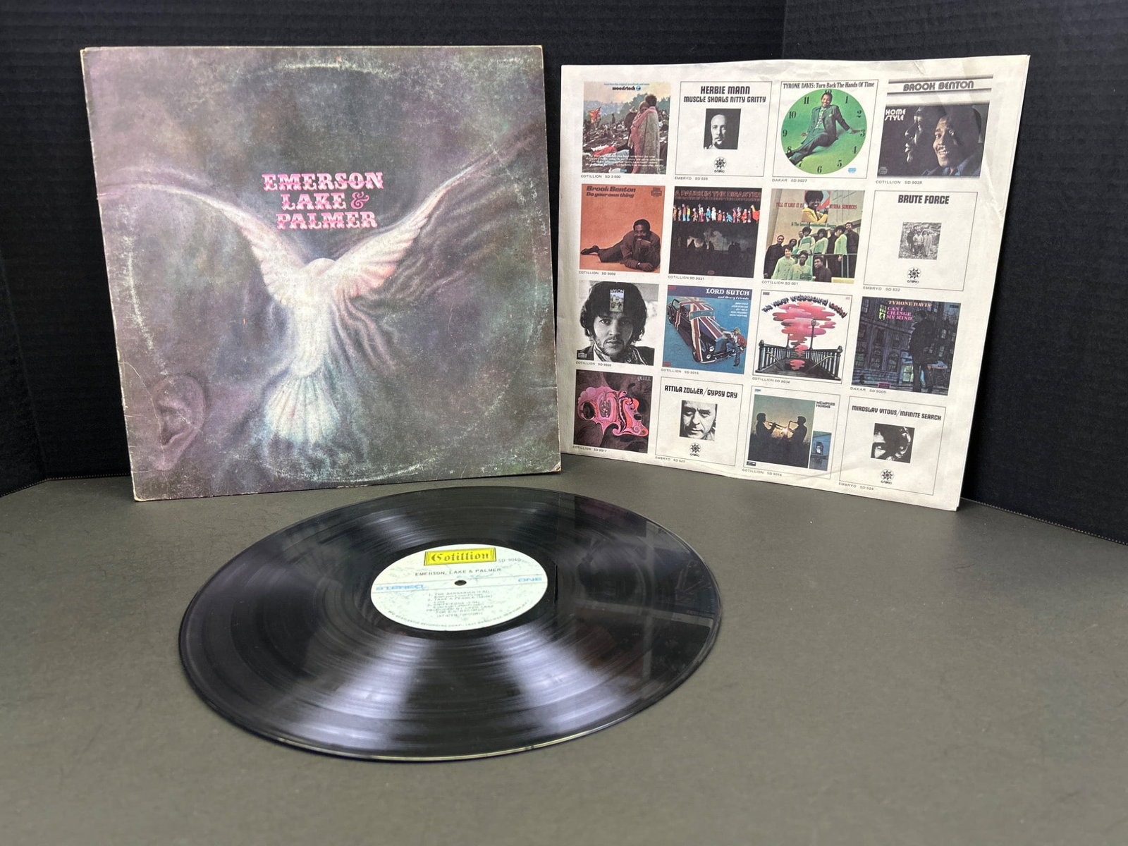 Emerson, Lake & Palmer Vinyl Record With Original Sleeve: This lot includes a vinyl record by Emerson, Lake & Palmer featuring the original album sleeve and inner lyric sheet. Released under the Cotillion label, catalog number SD 9040. Condition of the