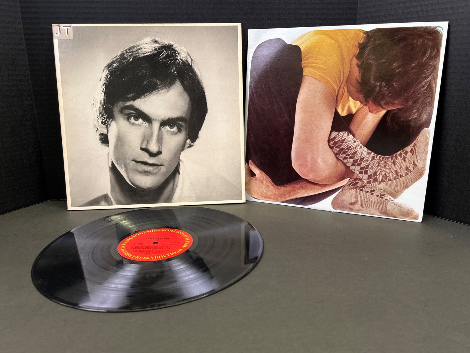 James Taylor Vinyl Record Album with Gatefold and Lyric Insert: This lot includes a vinyl LP record by James Taylor. The album features a gatefold outer sleeve with photography and a lyric insert included. The record appears to have been produced under Warner