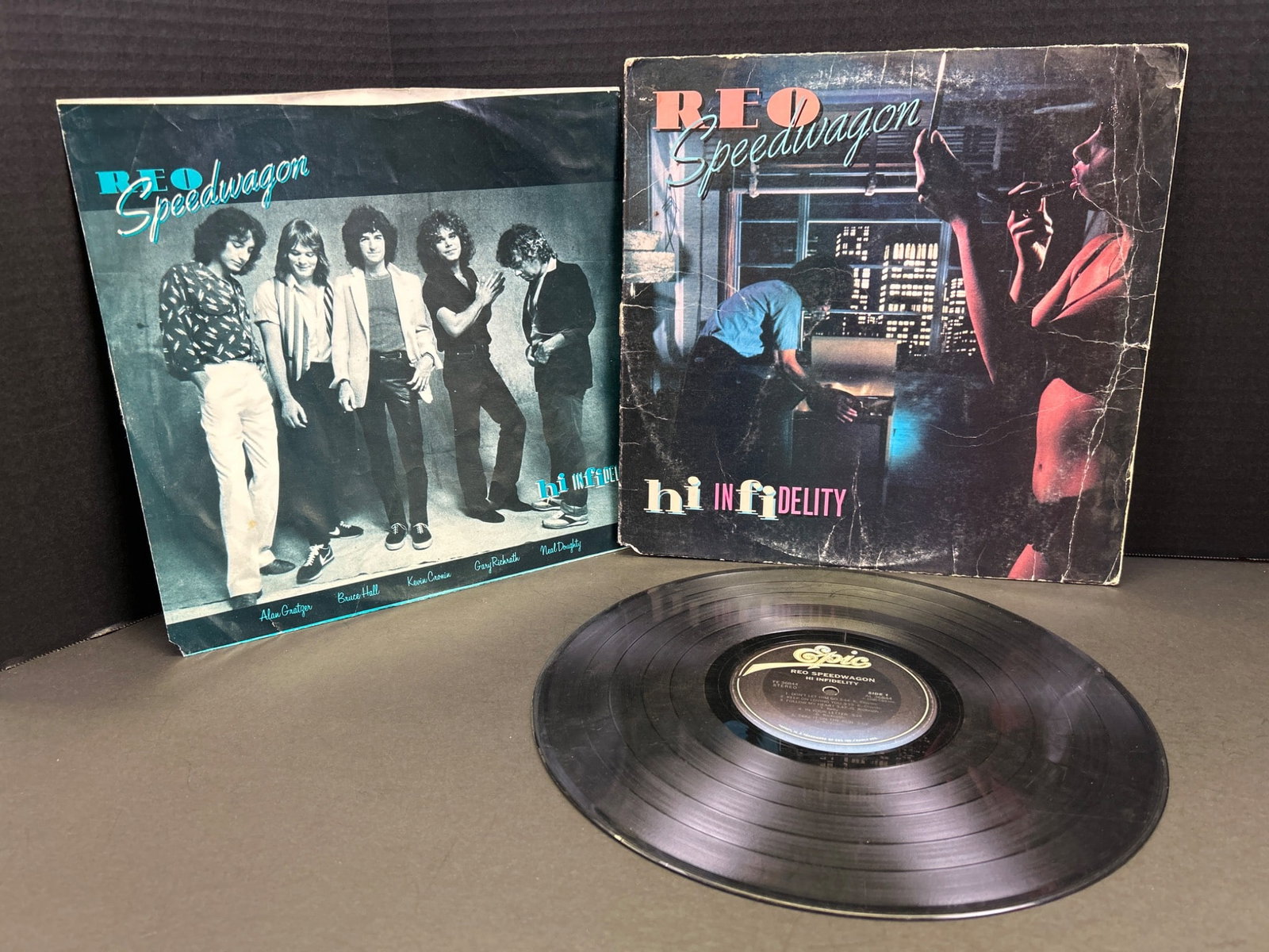 REO Speedwagon â€˜Hi Infidelityâ€™ Vinyl Record with Original Sleev: This listing features the â€˜Hi Infidelityâ€™ vinyl album by REO Speedwagon, released in 1980 under the Epic Records label (Catalog No. FE 36844). The record includes 