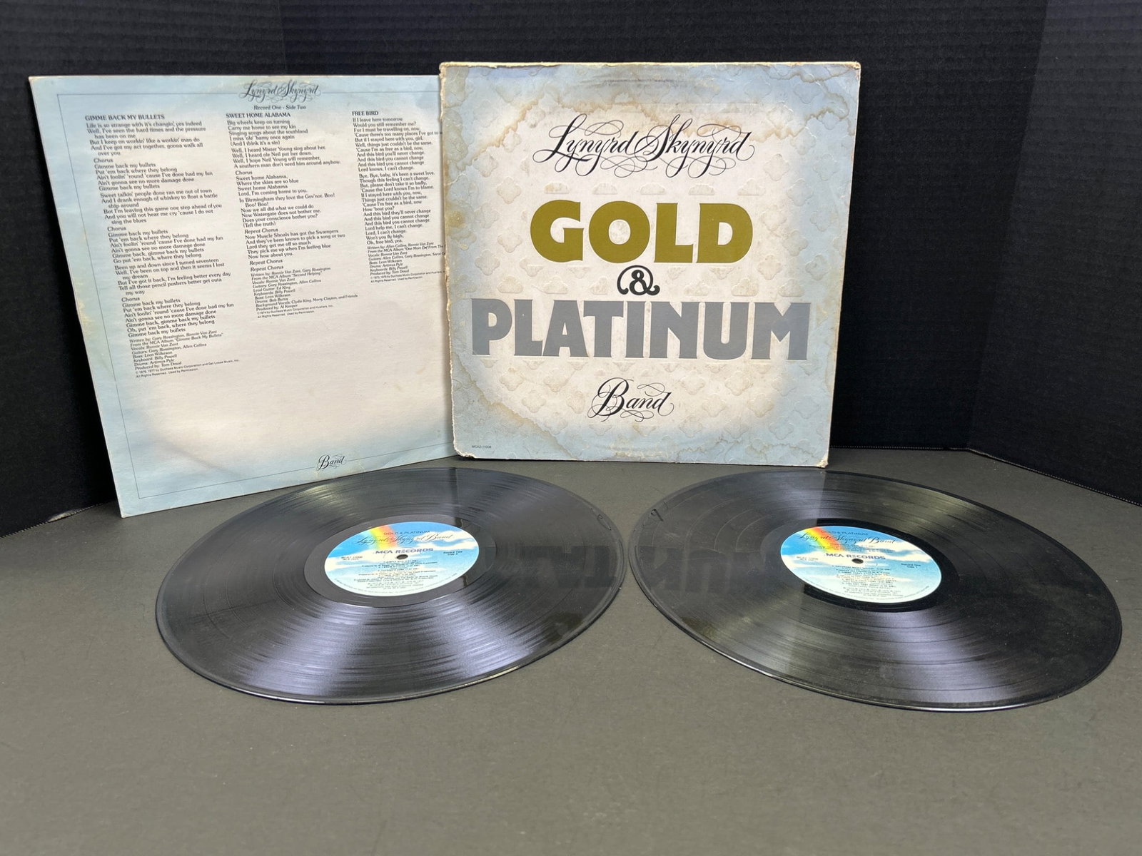 Lynyrd Skynyrd Gold & Platinum Double Vinyl LP Set with Gatefold Cover: This lot includes Lynyrd Skynyrd's 'Gold & Platinum' vinyl record set consisting of two LPs. Manufactured by MCA Records, catalog number MCA2-11008. The package features a gatefold cover with artwork