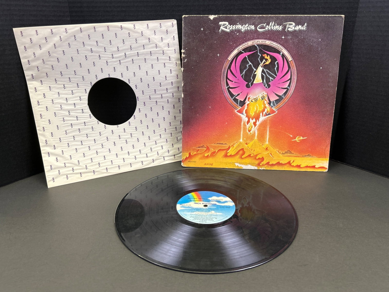 Rossington Collins Band Vinyl Record with Original Sleeve and Insert: Rossington Collins Band vinyl record, featuring original sleeve and insert. The record label shows MCA Records identification. Wear is visible on the edges of the outer sleeve, with some scuffs on the