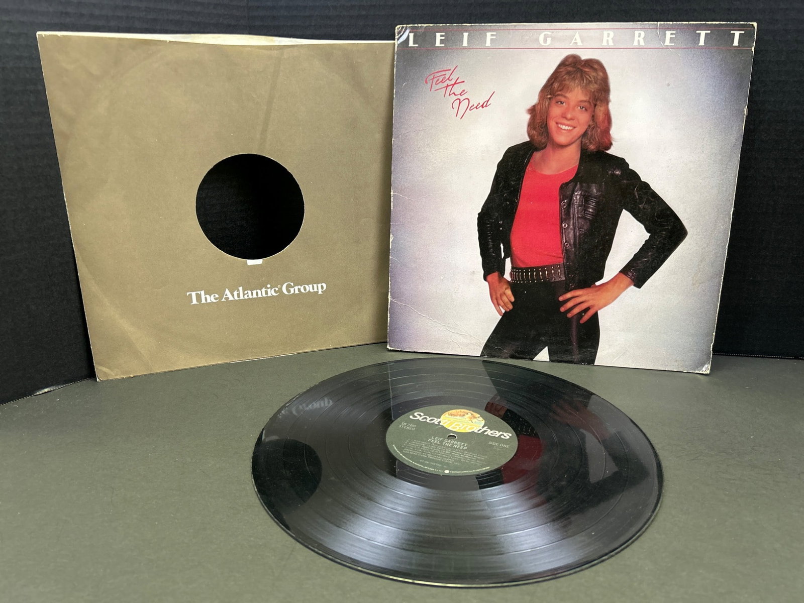 Leif Garrett 'Feel the Need' Vinyl Record LP with Sleeve: This Lot Includes a Leif Garrett Vinyl Record LP of the Album 'Feel the Need,' Released Under the Scotti Brothers Label. The Vinyl Measures Approximately 12 inches in Diameter and Includes Both the Fr