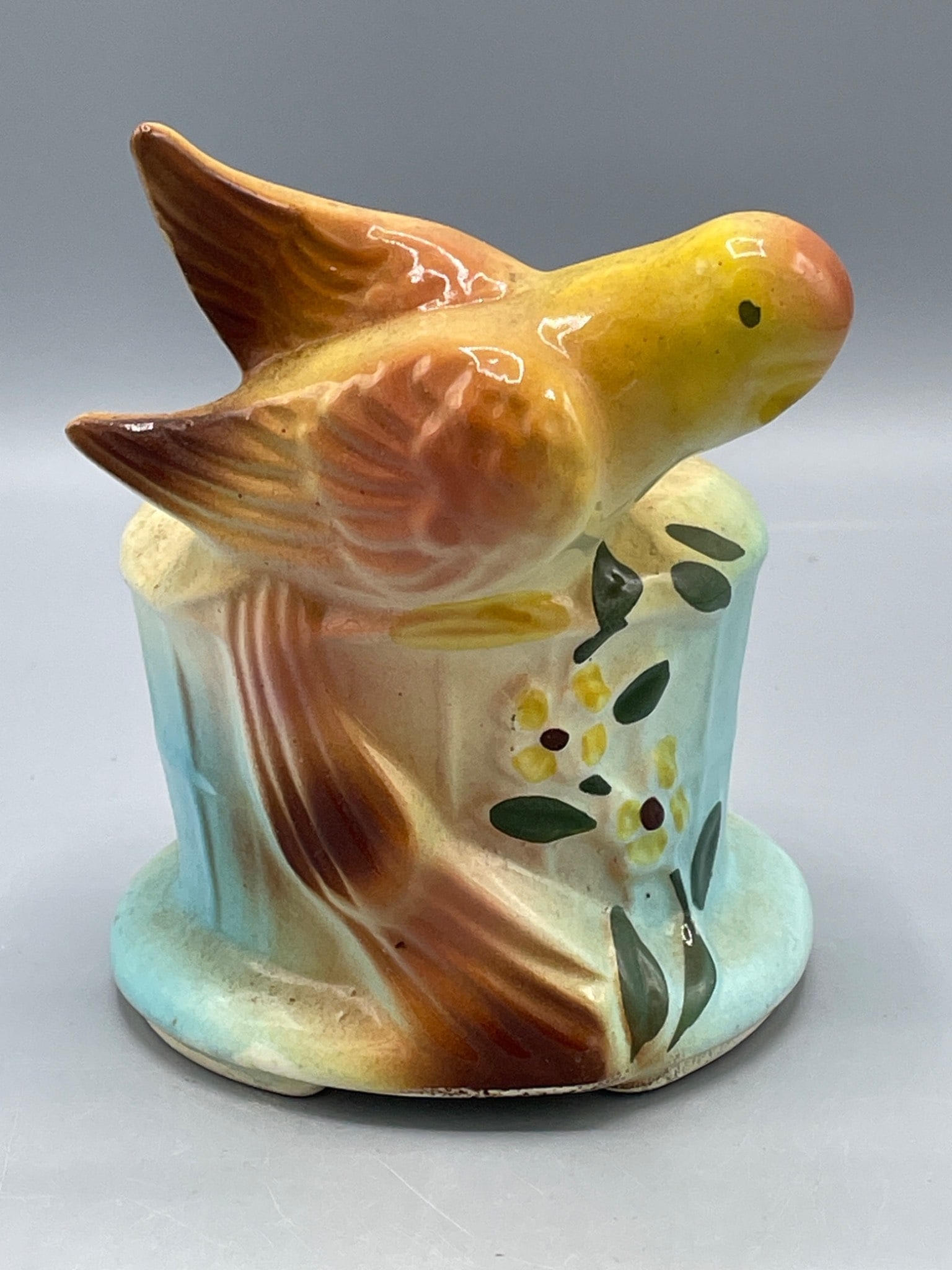 Ceramic Bird-Shaped Decorative Vase, USA Marked, Approx. 6 Inches Tall: This item is a ceramic vase featuring a bird motif with a blend of pastel colors. It measures approximately 6 inches in height and is marked 'USA' on the reverse. The vase appears to have an opening