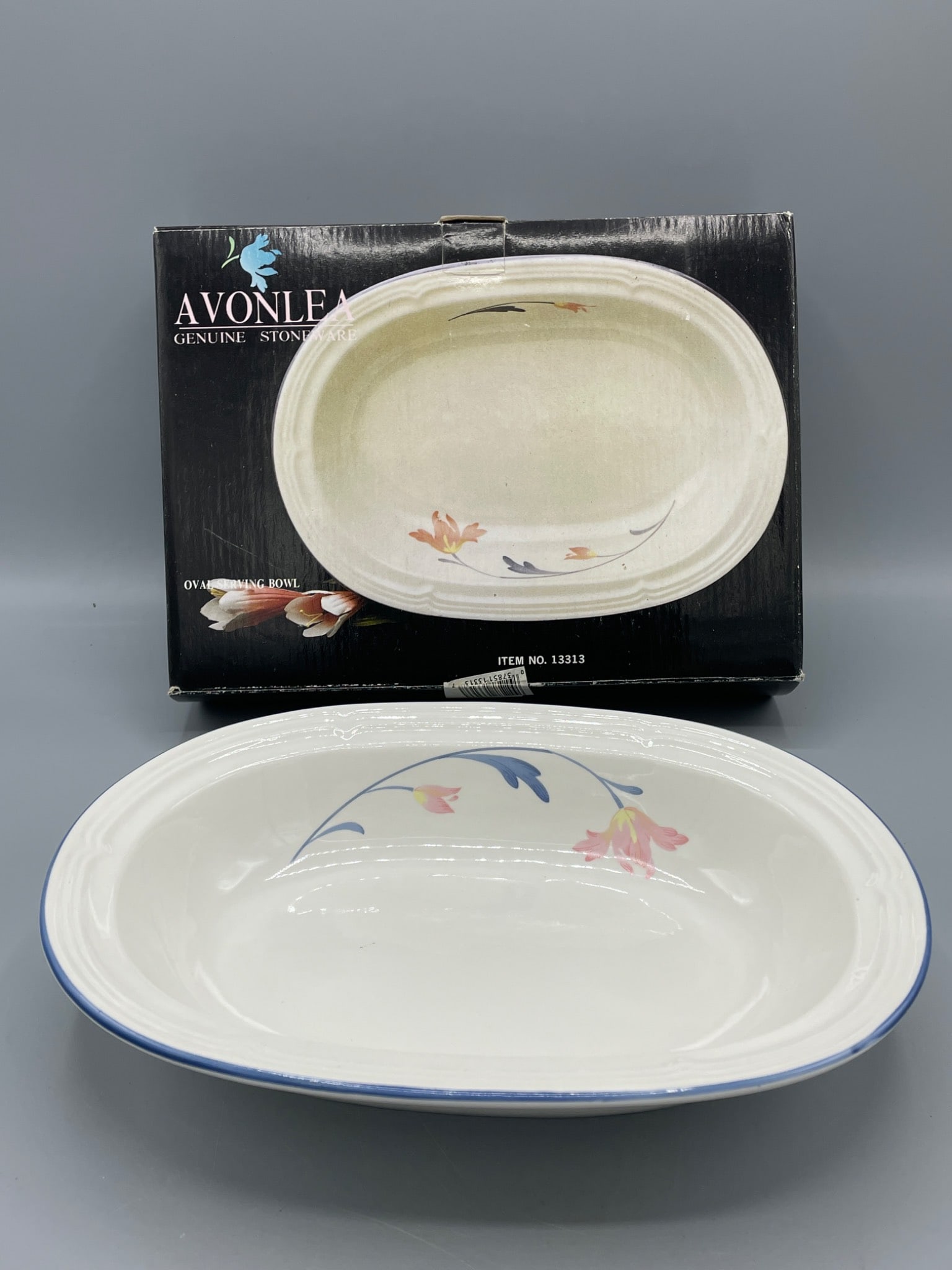 Avonlea Genuine Stoneware Oval Serving Bowl with Floral Design: Avonlea Genuine Stoneware Oval Serving Bowl, Item No. 13313. Features a floral design with blue trim. Oven-to-table, dishwasher, and microwave safe. Made in China for Citation Companies. Bowl