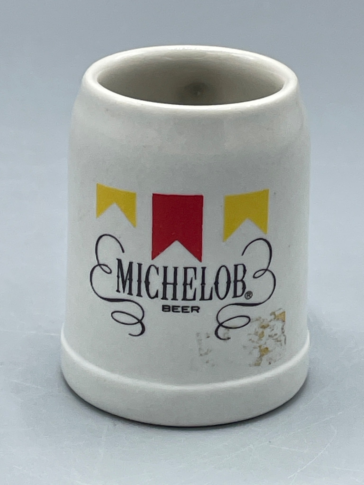 Michelob Beer Ceramic Mini Mug Made in Brazil: This is a ceramic mini mug featuring the MicheloB Beer logo and design. Approximately 2.5 inches tall, as shown in photo with ruler for reference. It is marked on the bottom as made in Brazil by