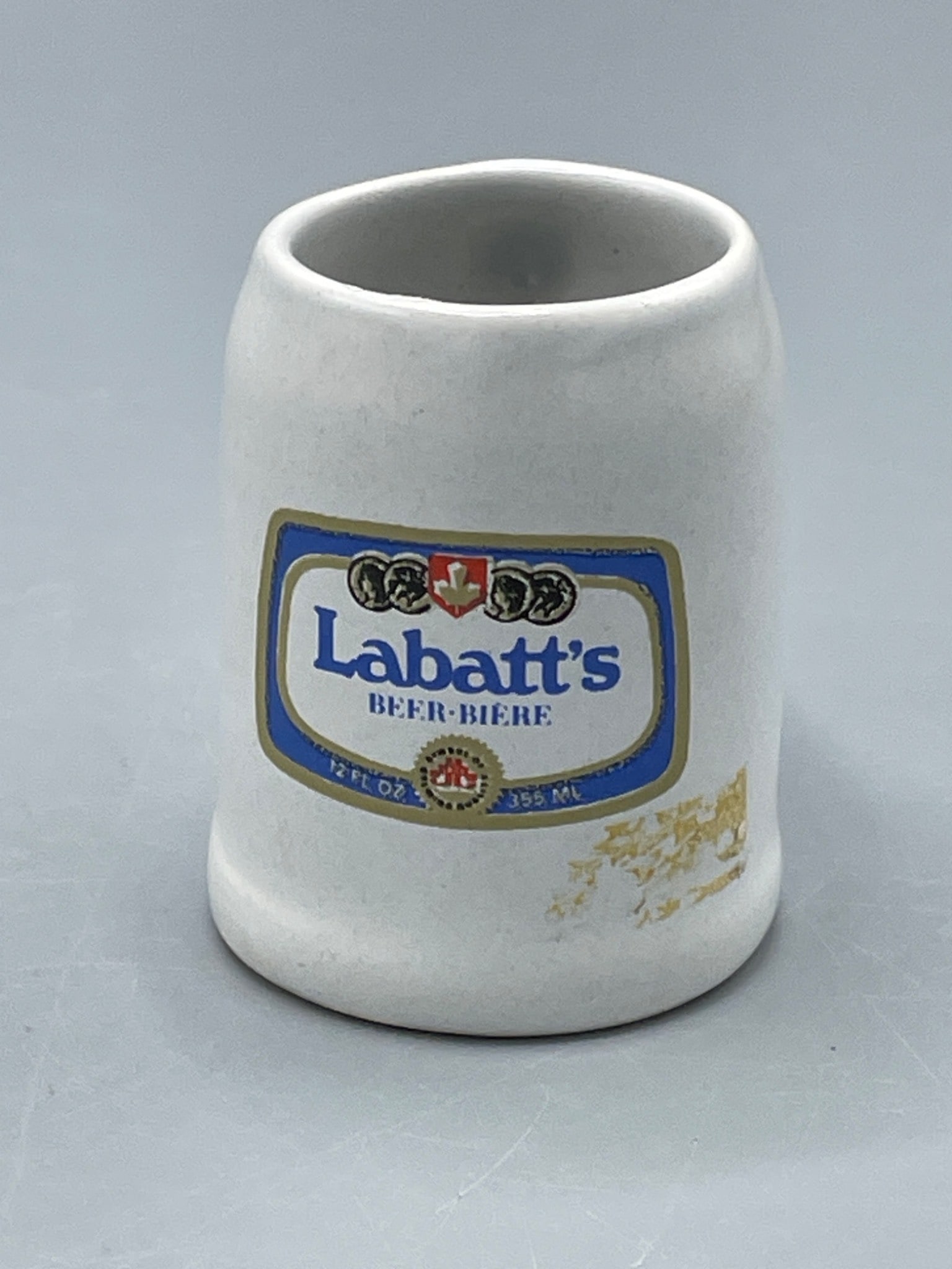 Labatt's Beer-Biere Ceramic Miniature Mug, Approximately 2.75 Inches Tall: A ceramic miniature mug featuring a Labatt's Beer-Biere logo on the front. The mug stands at approximately 2.75 inches tall, as measured with a ruler. The base shows no maker's mark, and the mug