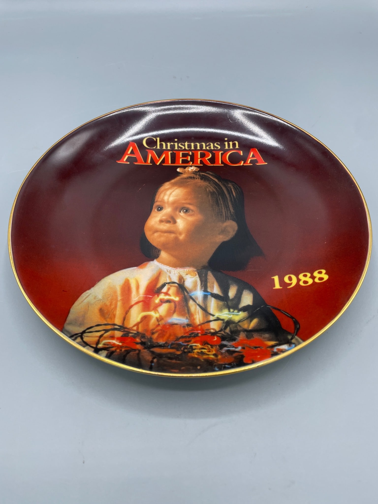 1988 Christmas in America Commemorative Collector Plate by Kmart: This is a 1988 collector plate titled "Christmas in America," sponsored by Kmart. The plate is from a limited edition (numbered 37749) produced to commemorate the publication of the collection