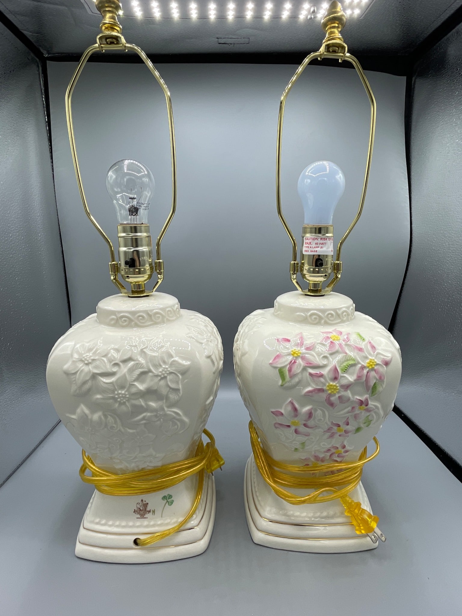 Belleek Ireland Porcelain Table Lamps, 22 Inches Tall, Pair: Matching Belleek Ireland porcelain table lamps with hand-embellished designs. Each lamp stands 22 inches tall (including harp and finial) and features floral motifs. Marked with the Belleek Ireland