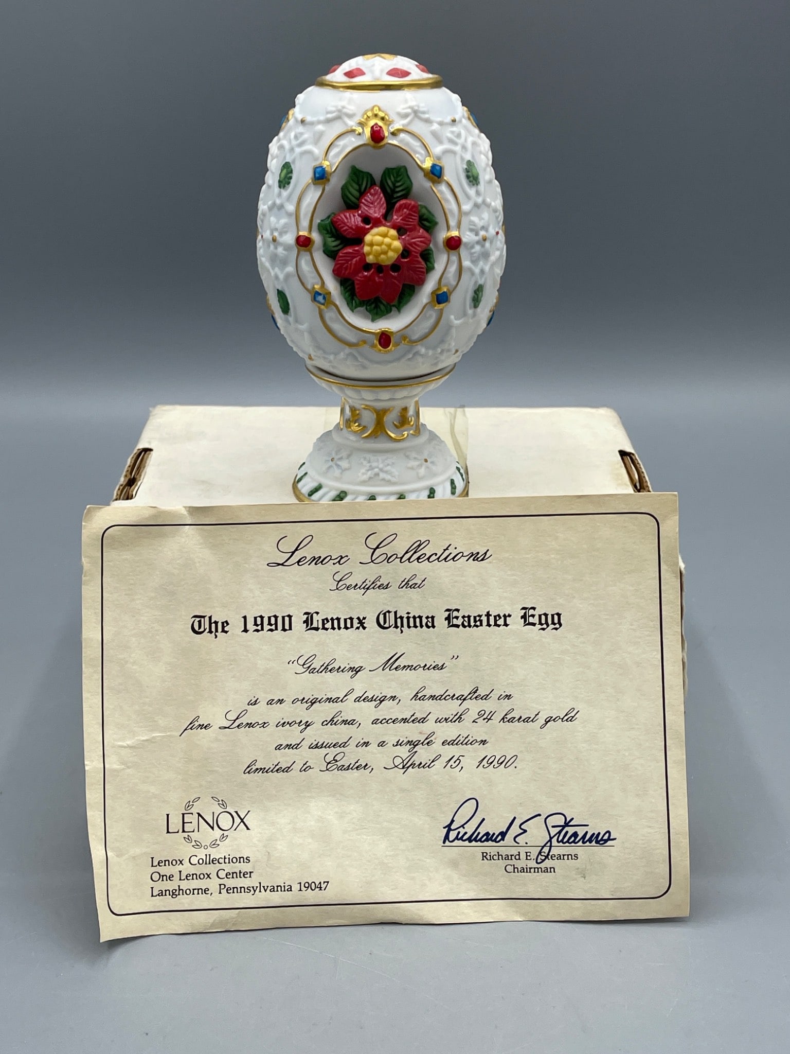 1990 Lenox China Easter Egg 'Gathering Memories' Handcrafted with 24K Gold: This Lenox China Easter Egg titled 'Gathering Memories' from 1990 is handcrafted and accented with 24K gold. It features an ornate floral design, including poinsettia accents, and comes from a single 