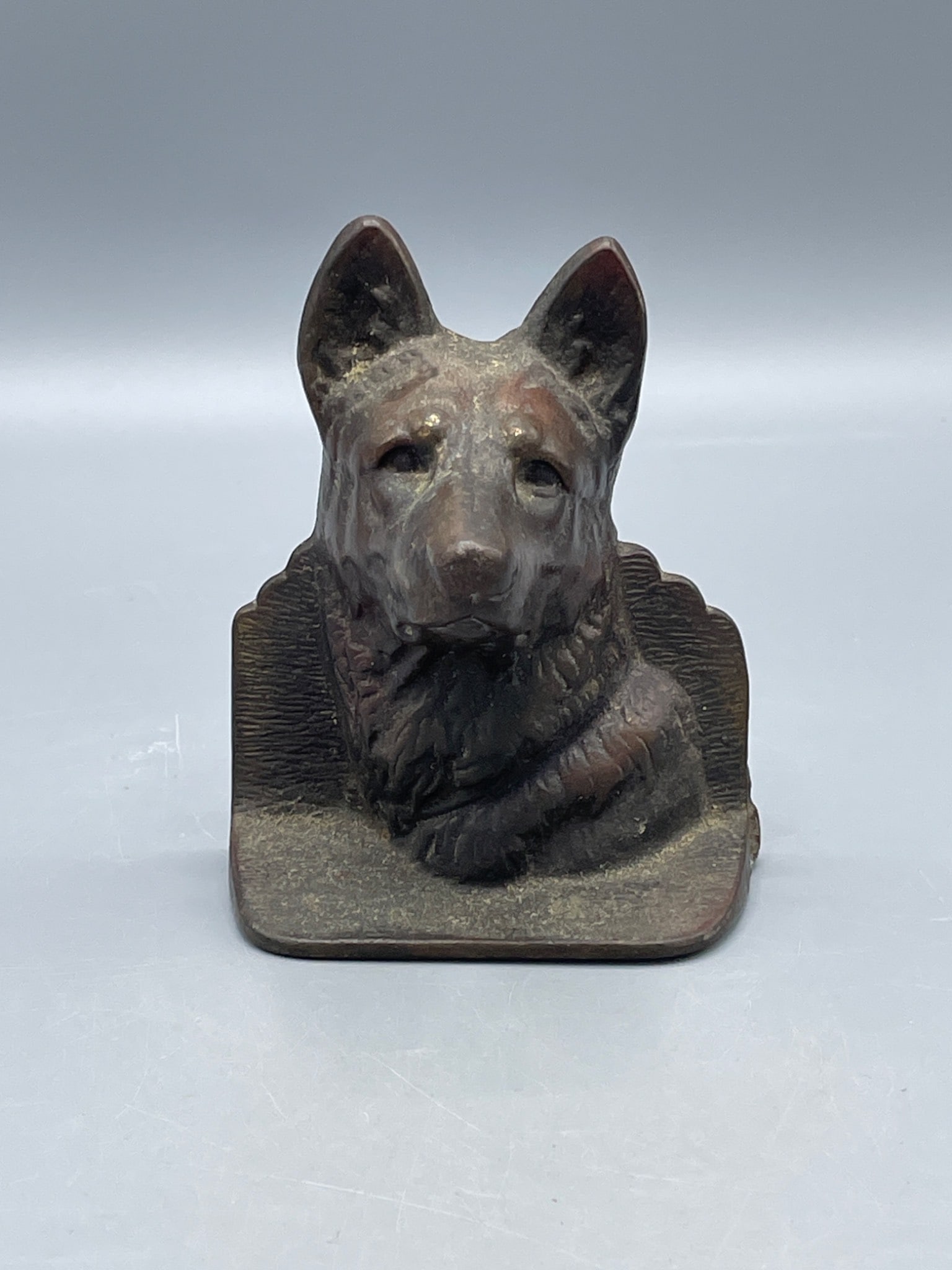 Cast Metal German Shepherd Dog Bookend or door stop: Single bookend featuring a German Shepherd dog, cast in metal. Includes decorative details and measures approximately 5 inches tall. Visible wear includes a red paint mark on the side and patina from