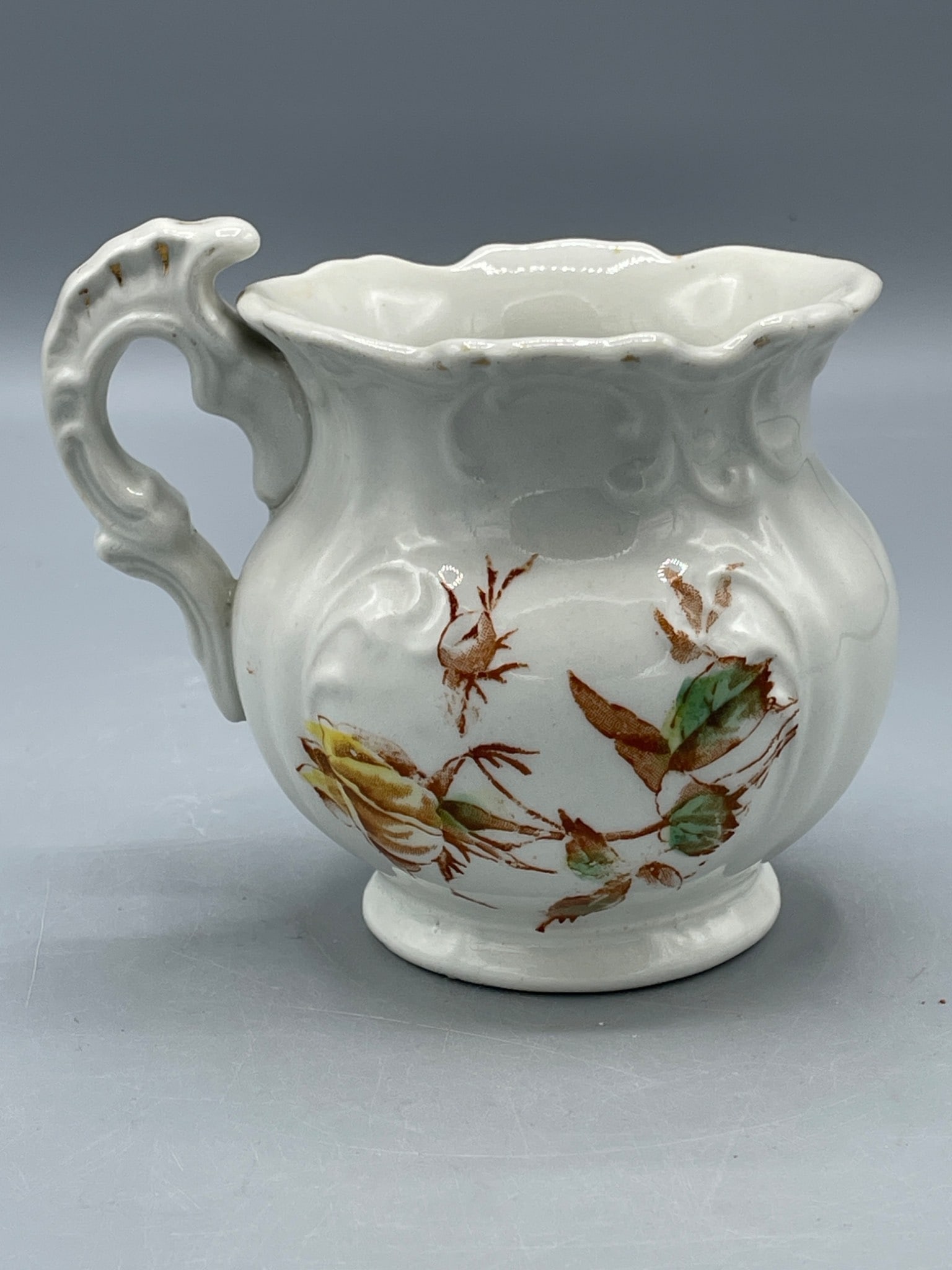 White Porcelain Creamer with Floral Design and Ornate Handle - 2