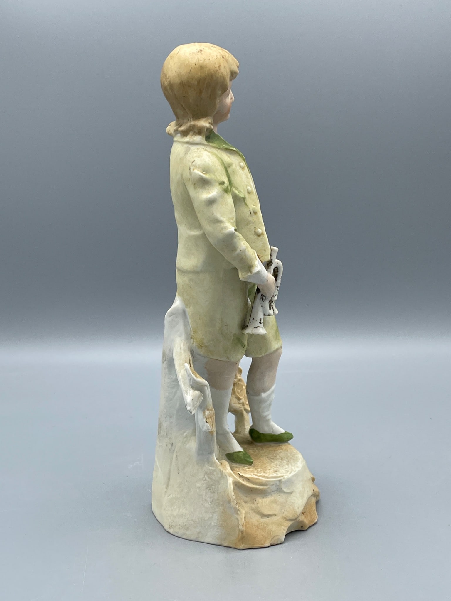 Porcelain Figurine of Boy Holding Horseshoe with Green and Yellow Outfit - 2